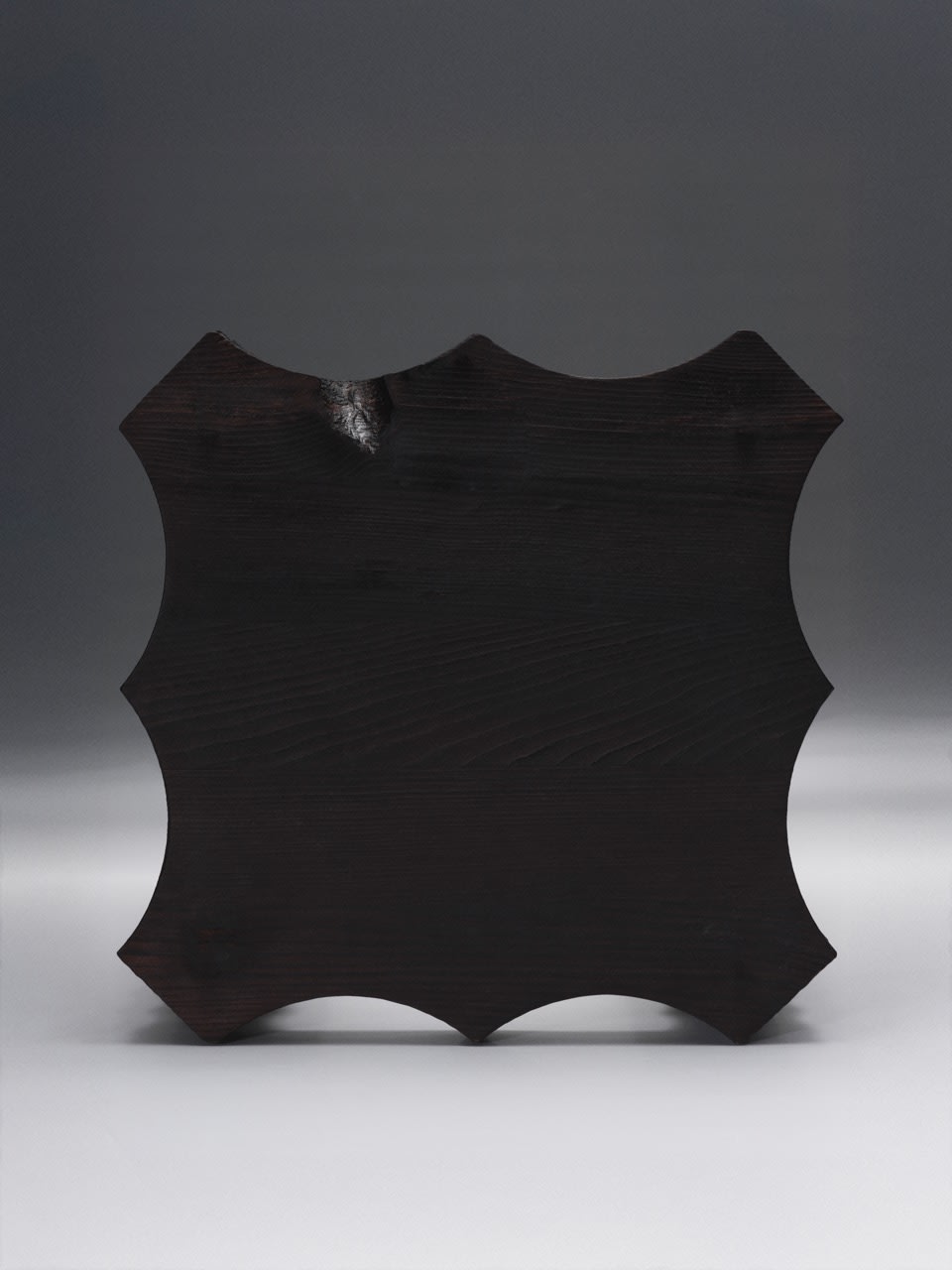 The Spiky Stool — front view of dark wood seat