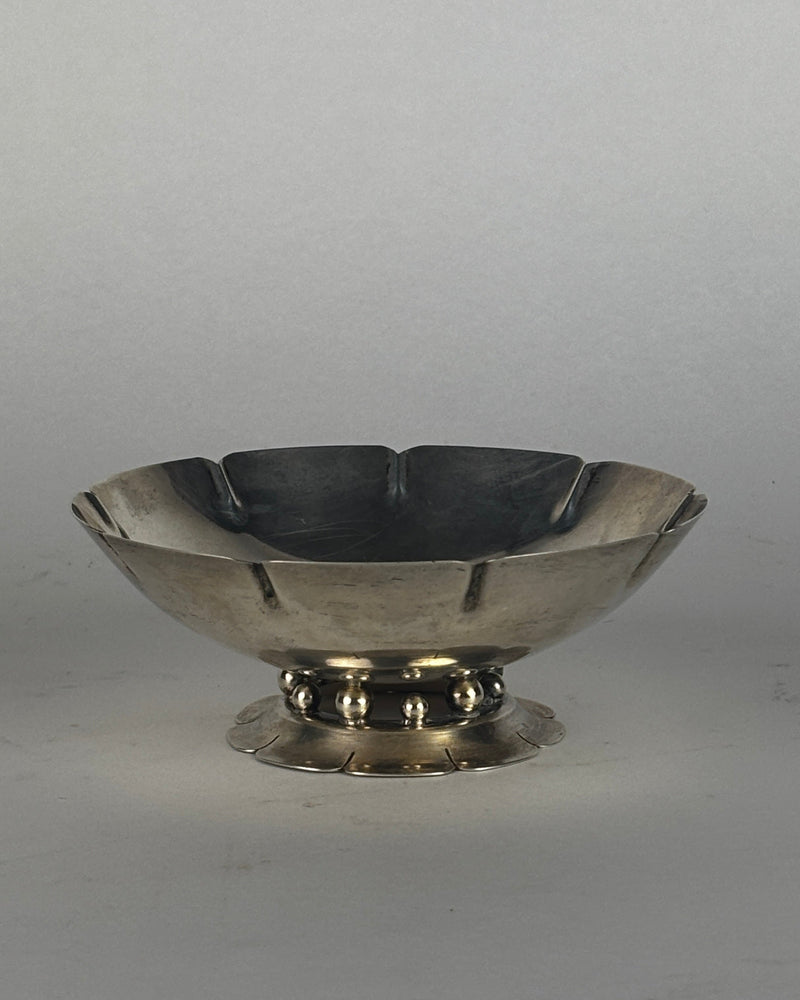 Sterling silver footed bowl with scalloped rim and decorative base