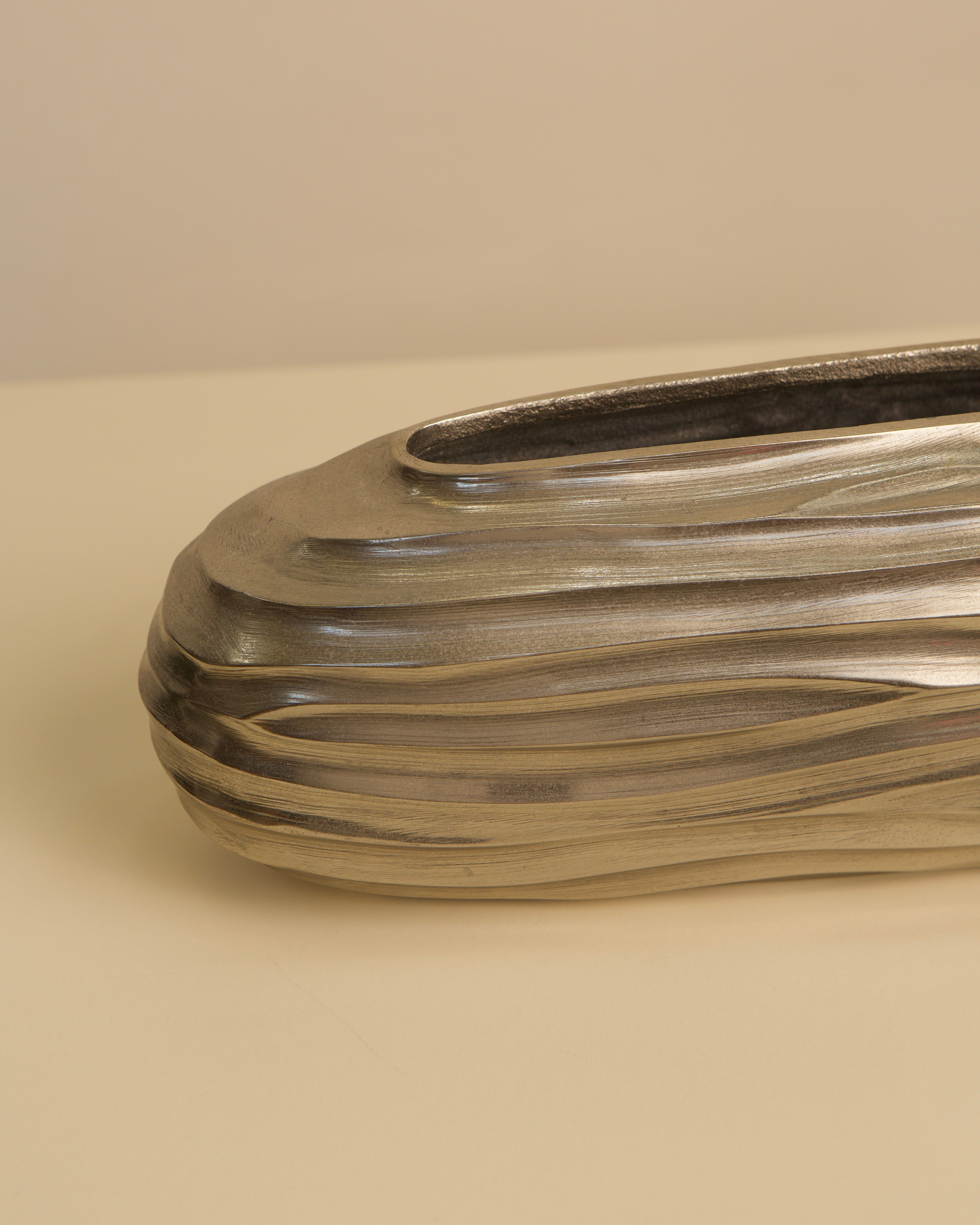 Cast aluminum vase detail showing horizontal ridged texture pattern