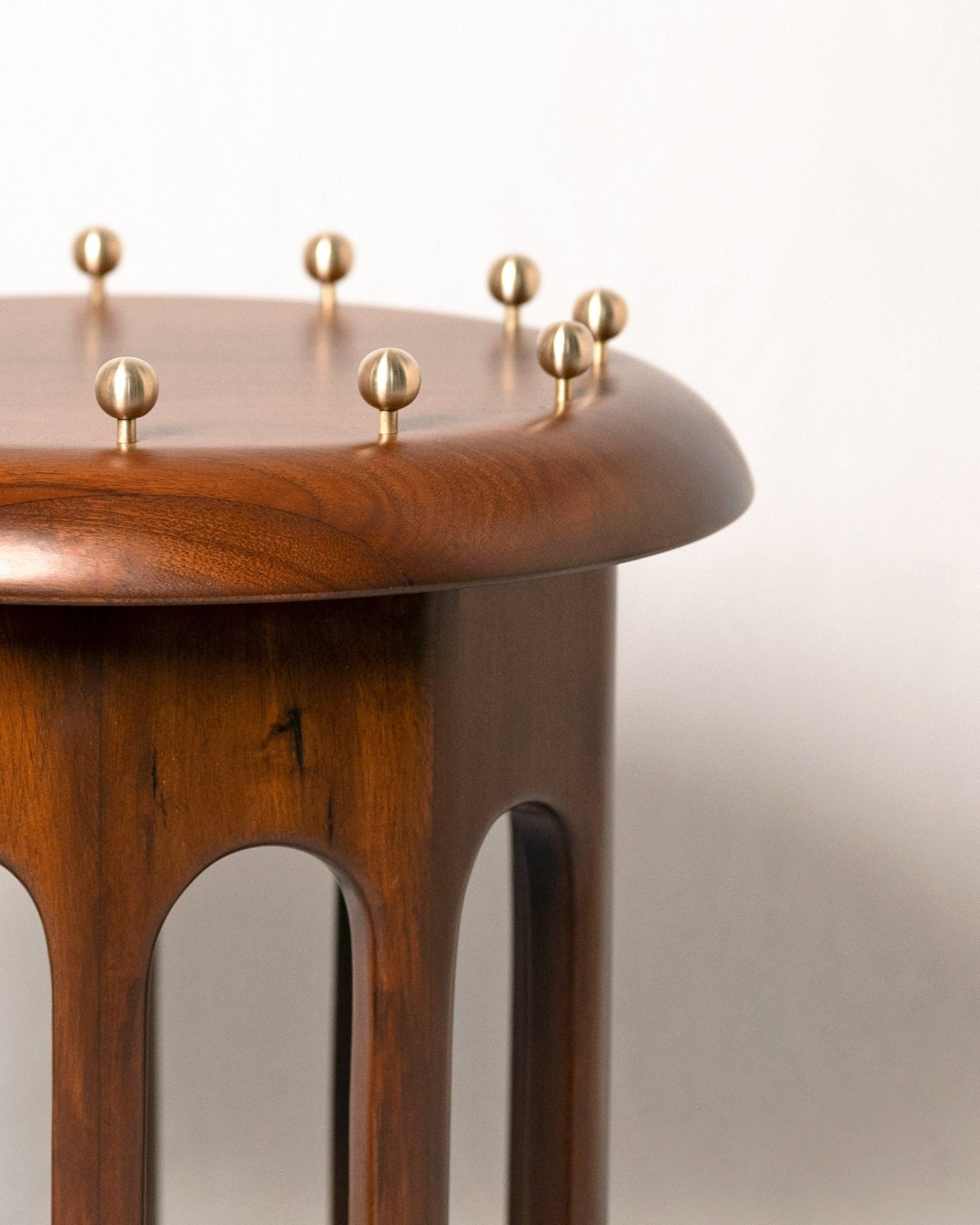Corona Side Table — side angle showing wooden base and brass accents