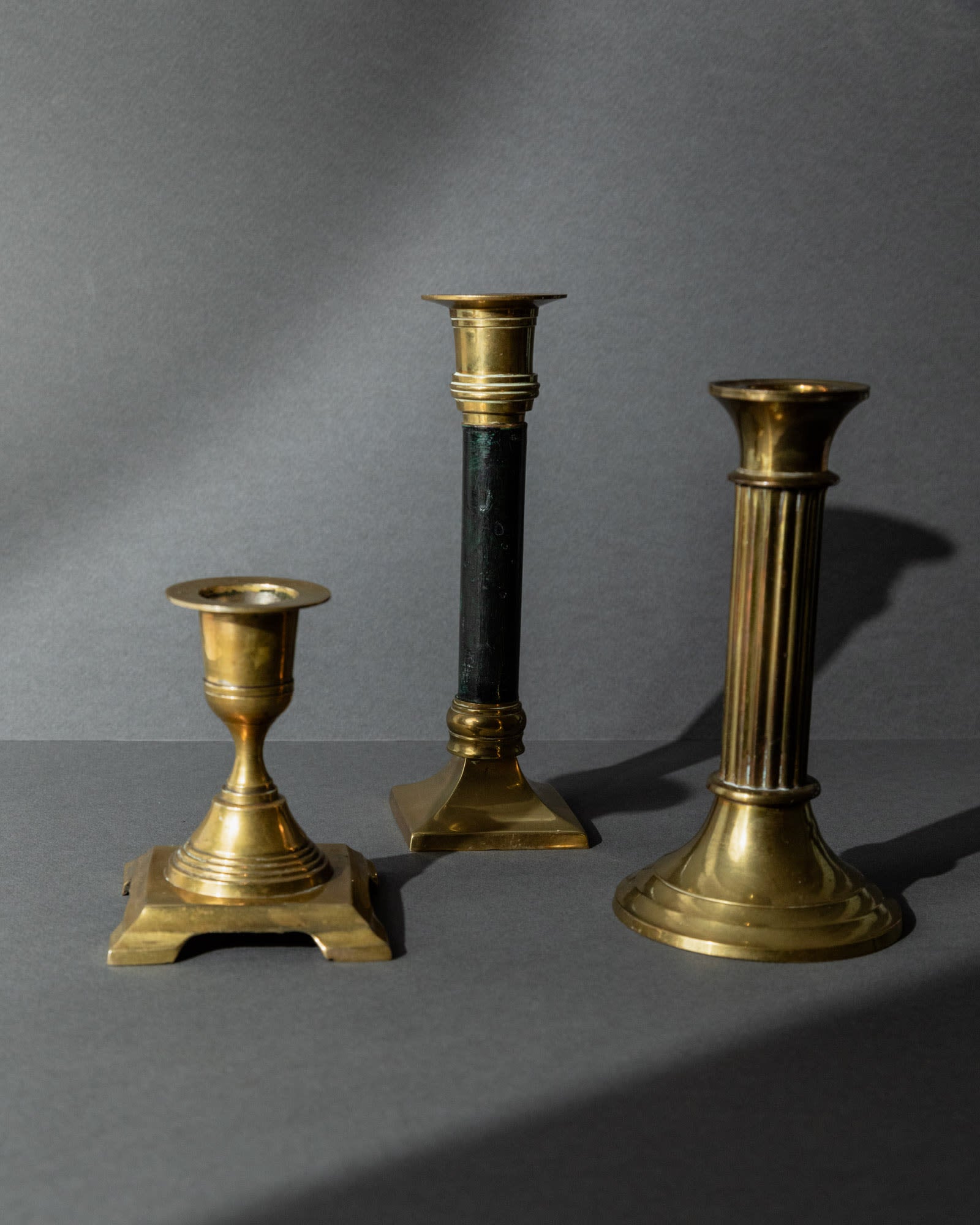 Vintage 1940s Brass Candleholders Set of 3, Mixed Shapes, Classic Antique Design — angled view highlighting different shapes