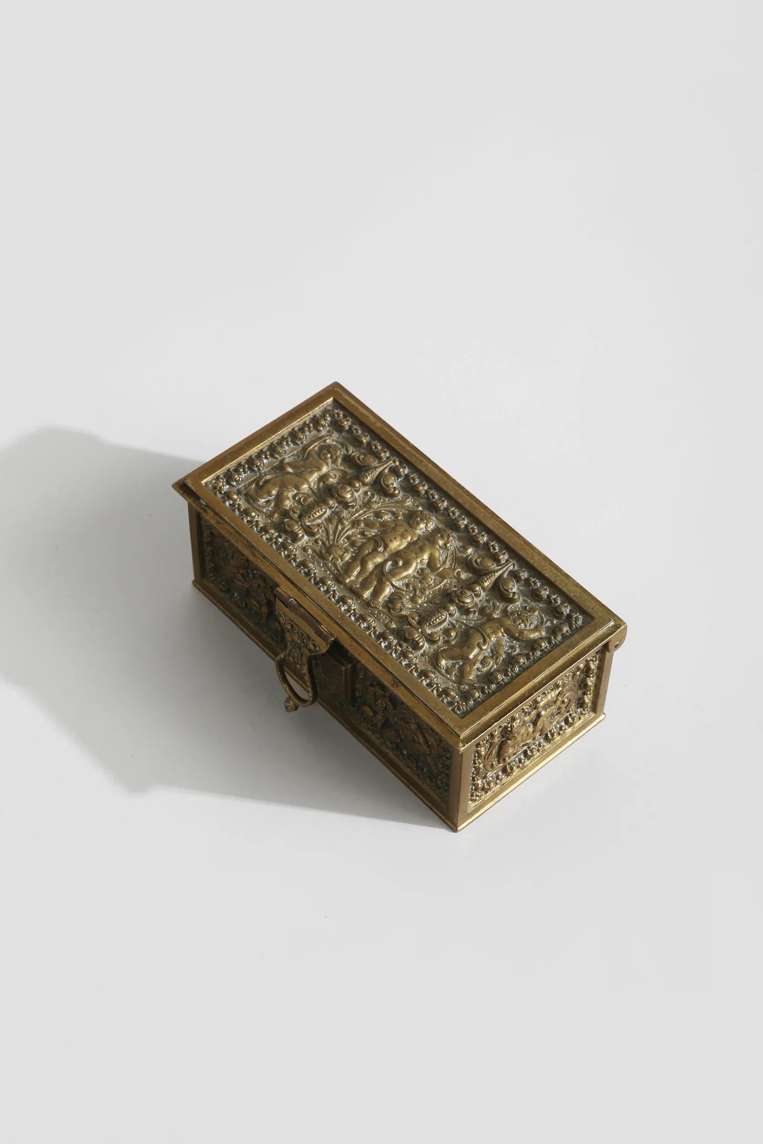 Brass Cherub Jewelry Box — angled view highlighting detailed brass design