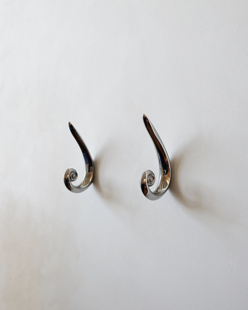 Noelle Hook - Titanium — close-up of polished titanium finish on wall