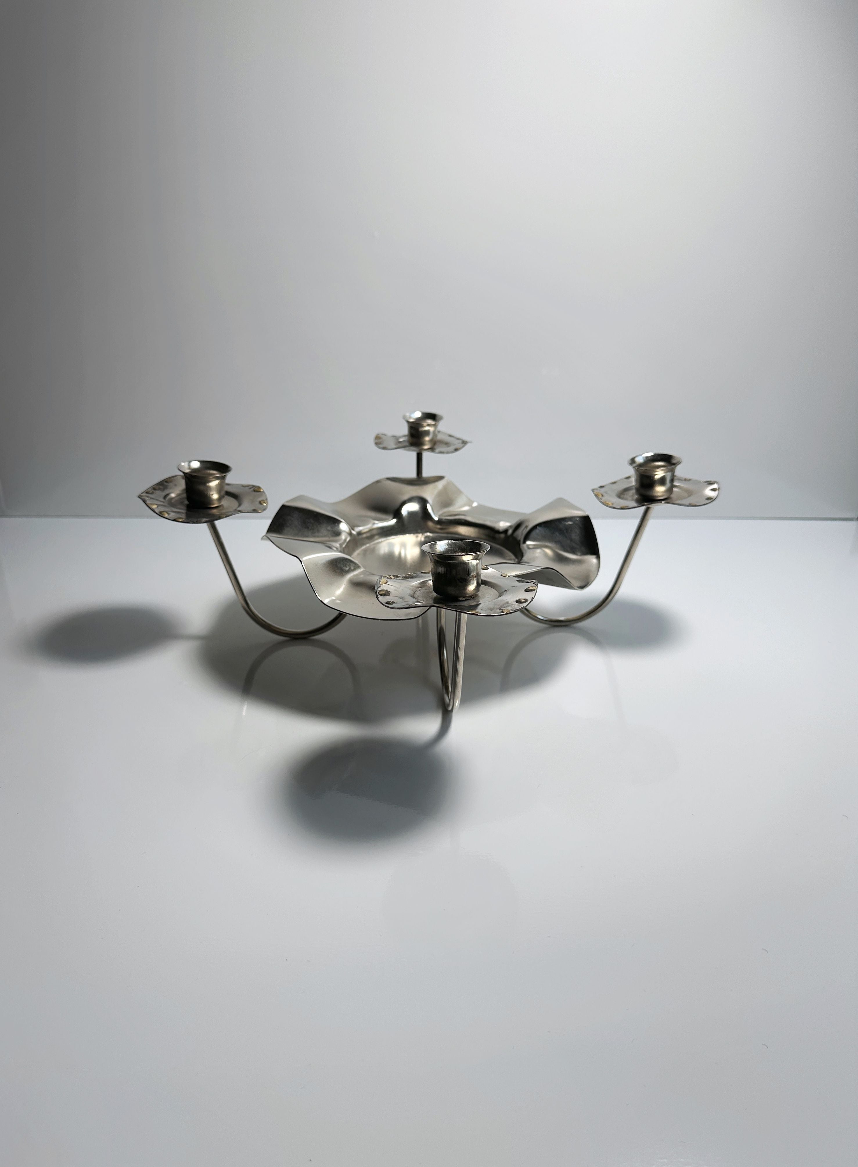 Silver Metal 1960s Candleholder — angled view on white surface