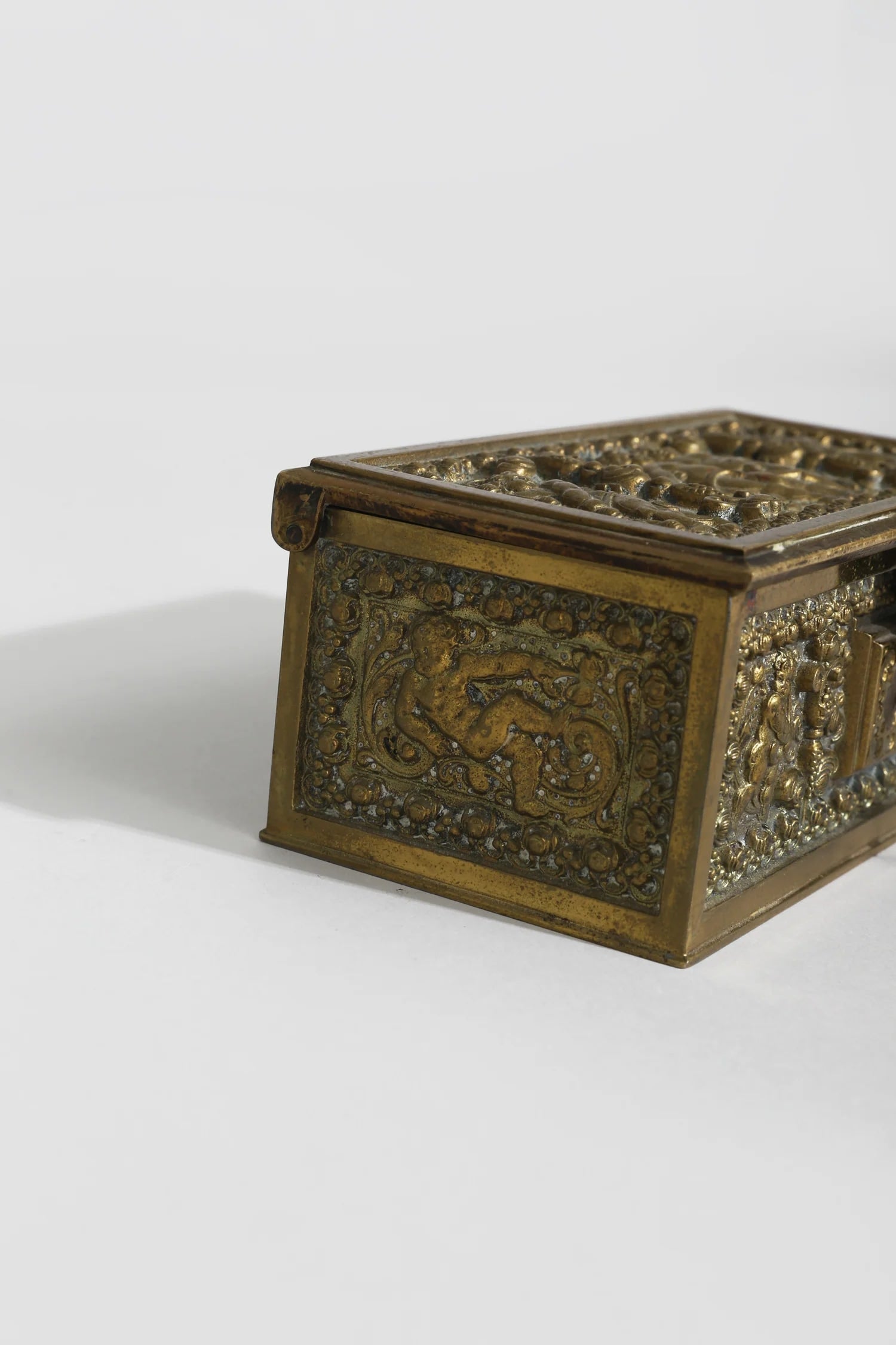 Brass Cherub Jewelry Box — top view highlighting detailed brass design