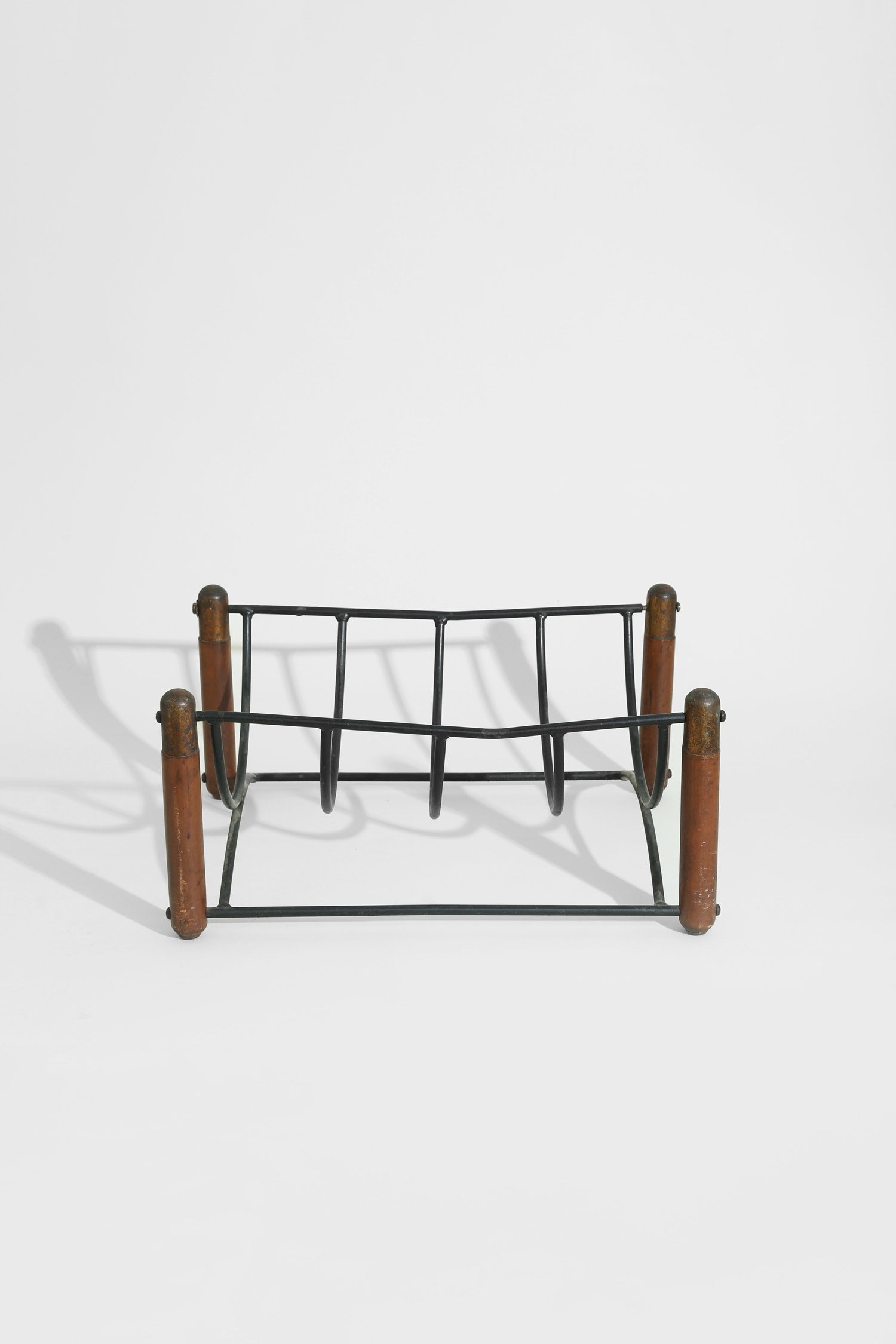 Mid-century Magazine Rack — side angle with black metal frame and wooden legs