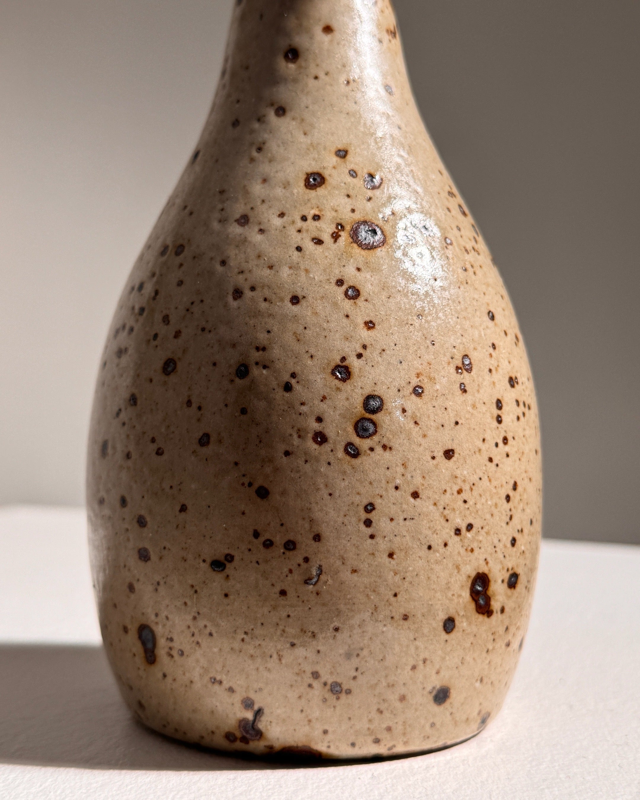 Speckled stoneware vase detail showing natural texture and spots