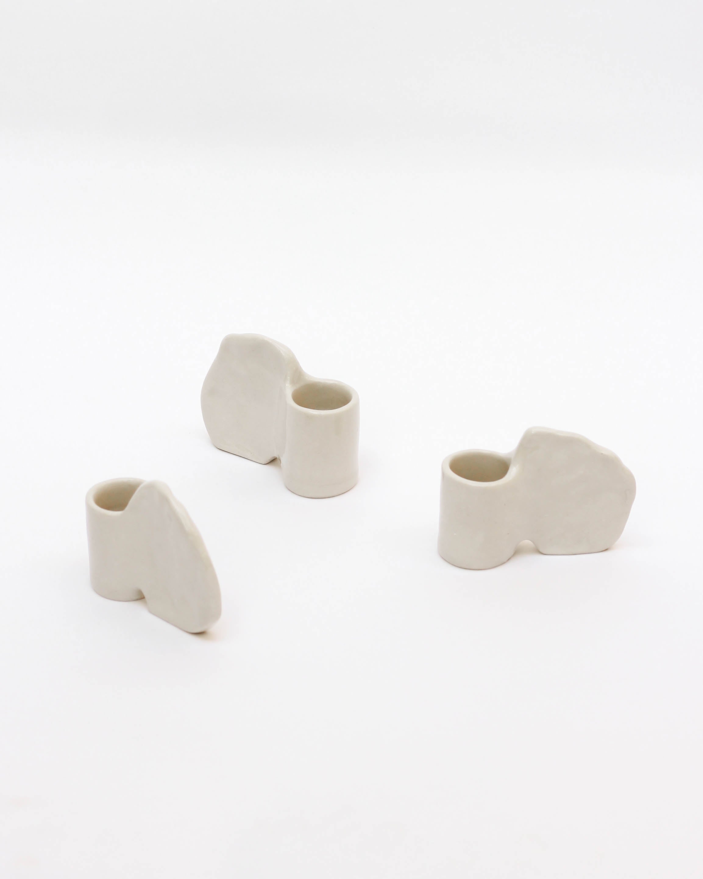 Candleholder in Stoneware with wing — top view of three white pieces