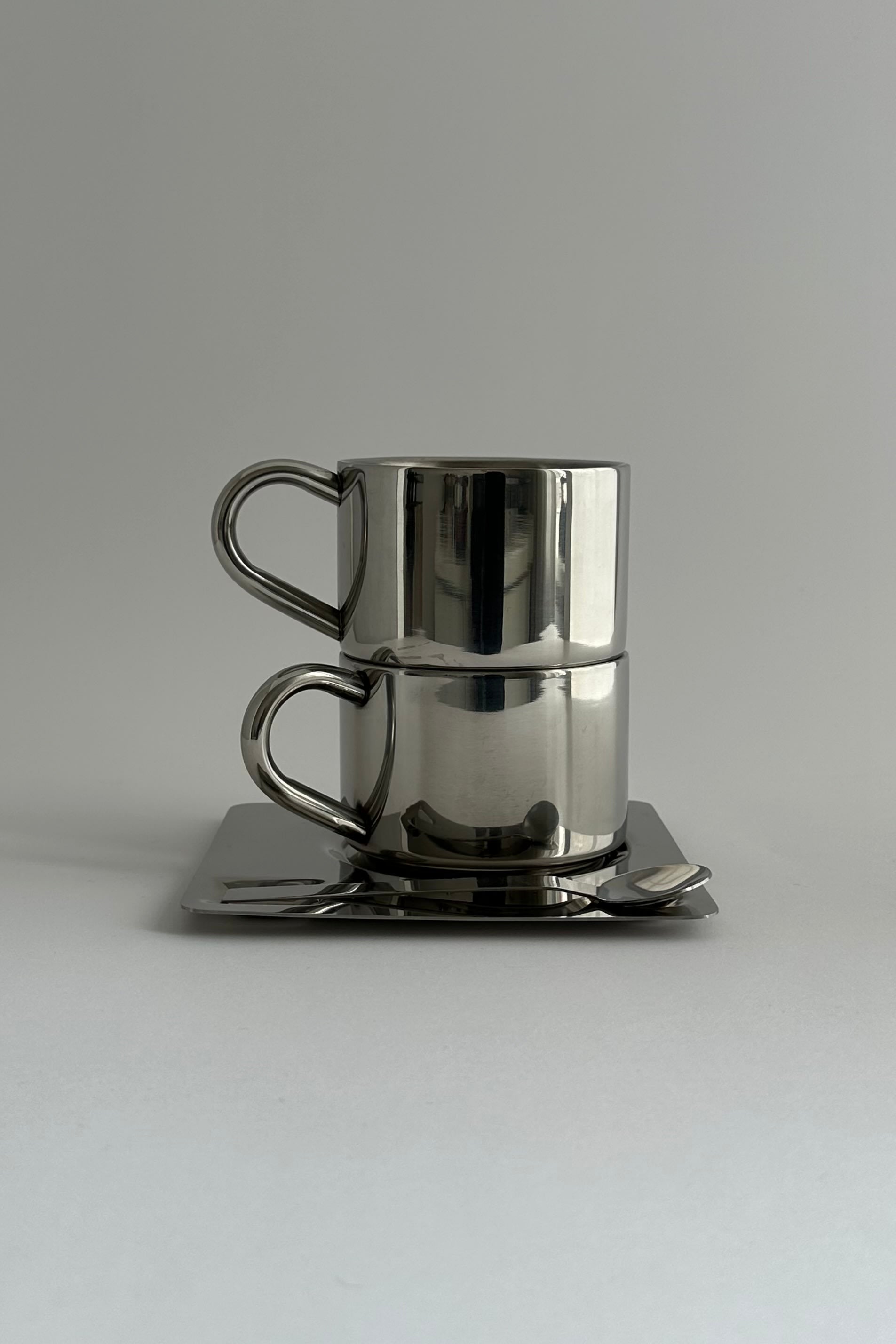 'HEDONISM' stainless steel cup with saucer — alternate view