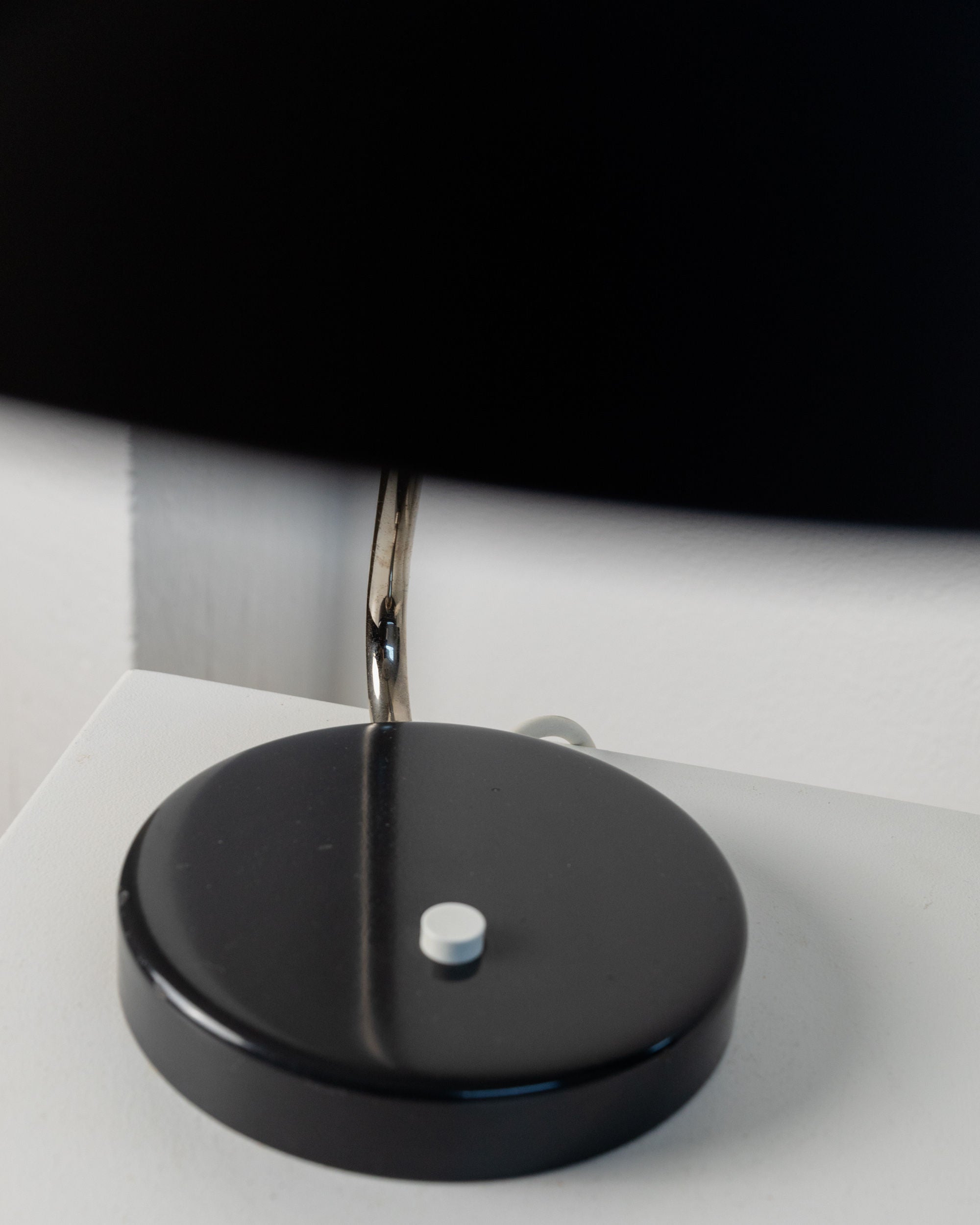 Table Lamp by Kaiser Idell, 1960s — close-up of black metal base