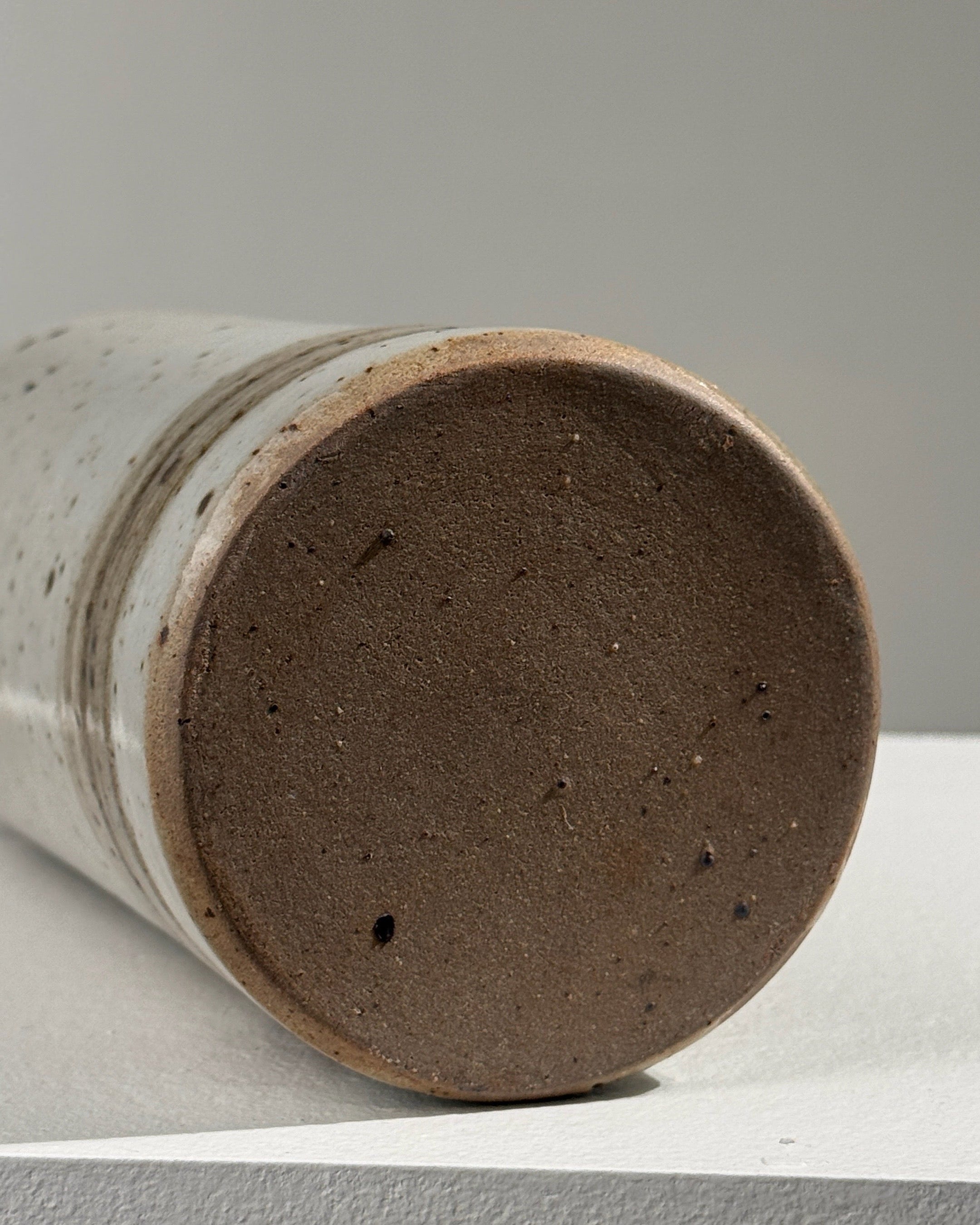 Bottom view detail of pyrited stoneware bottle showing textured base