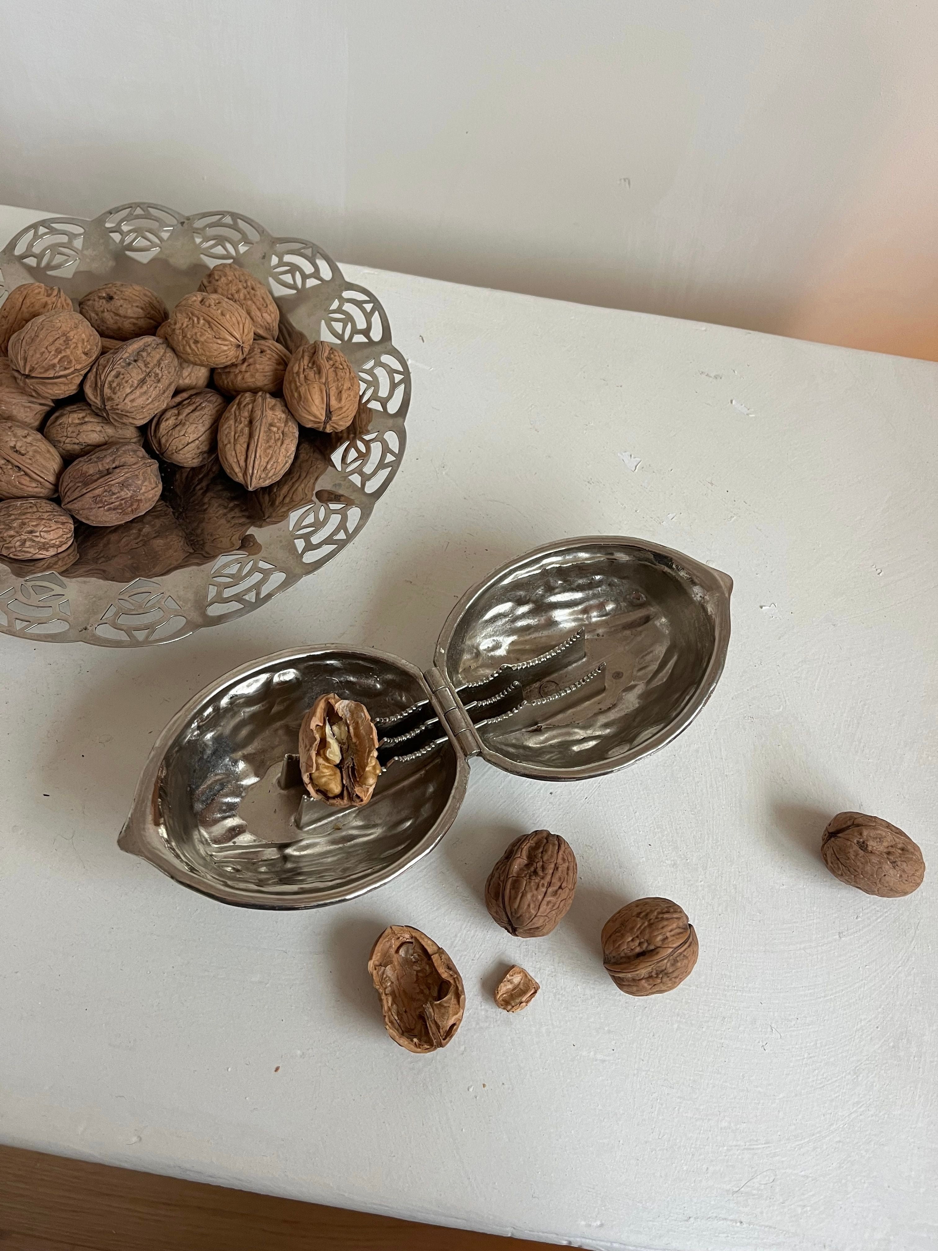 Nutcracker — overhead view on white table with walnuts