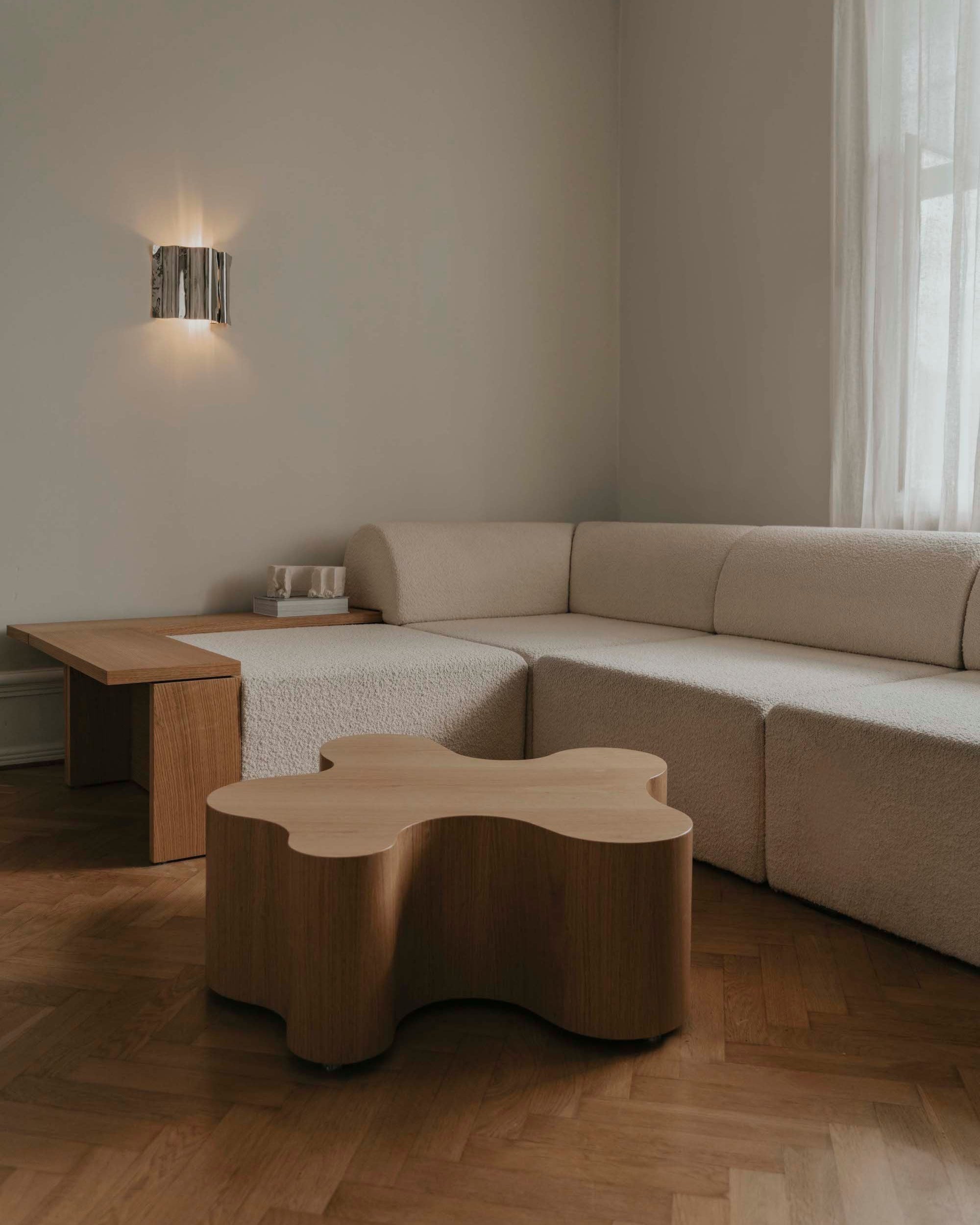 Oak root coffee table with curved organic form in modern neutral living room