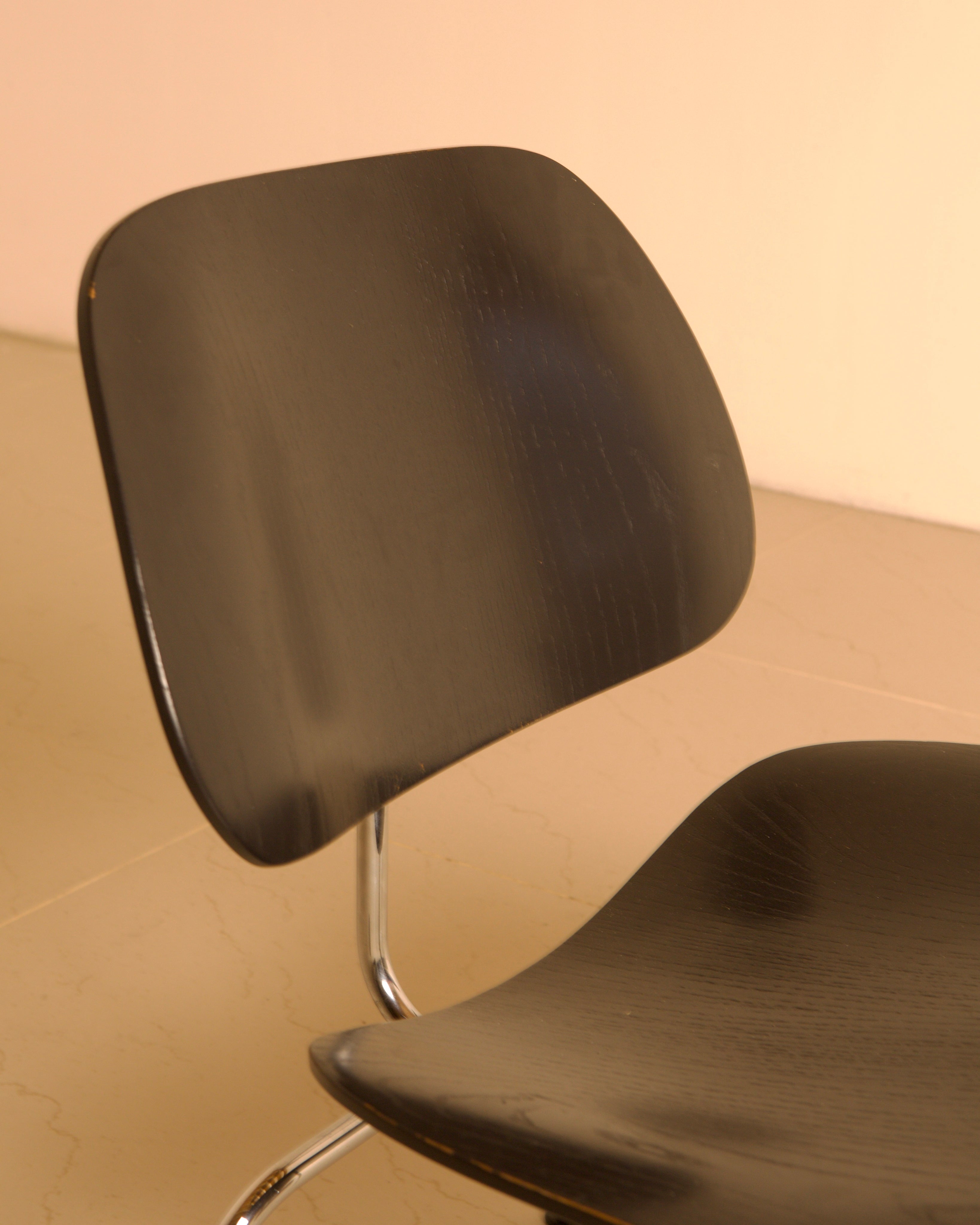 LCM Chairs by Charles and Ray Eames for Herman Miller, 1960s — close-up of black wood seat and backrest
