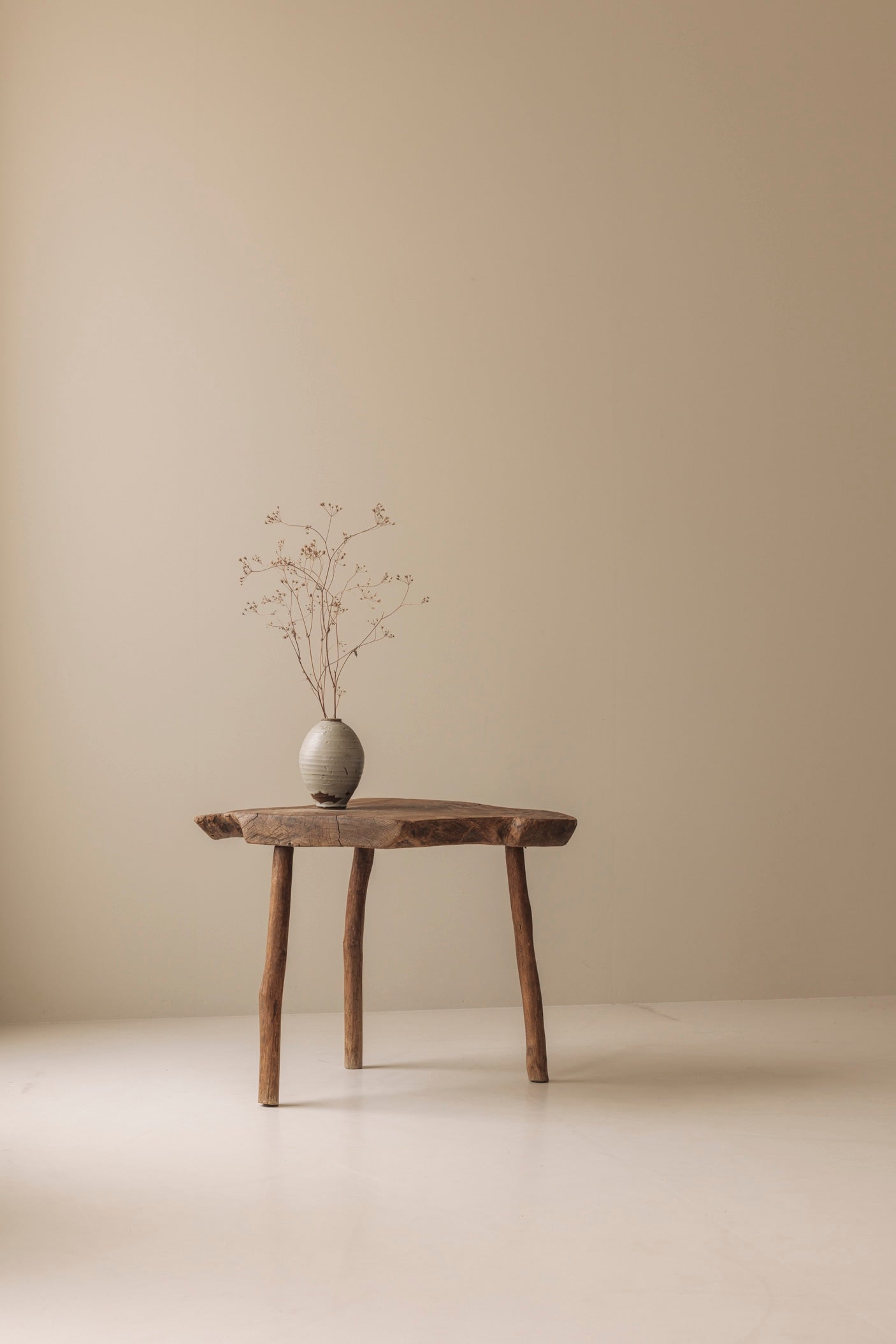 Sculptural French tripod side table in solid elm dating from the 1950s. — in context