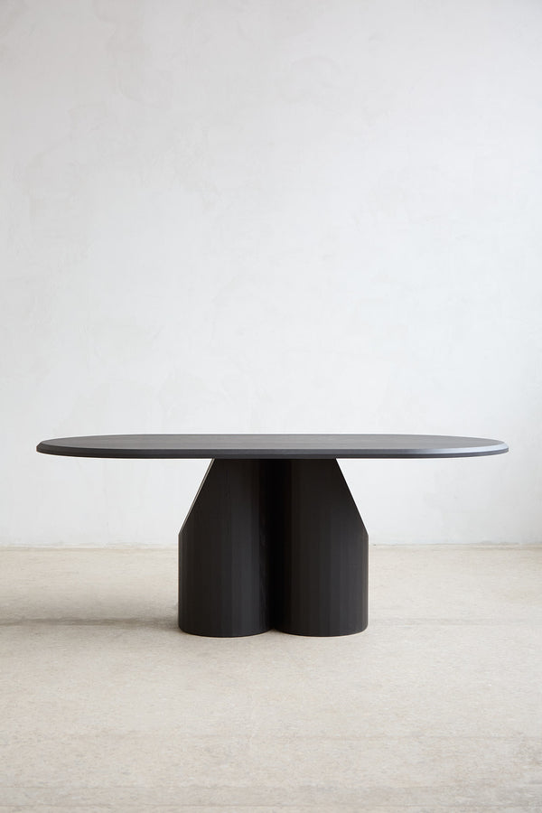 Barrow Dining Table in Solid Wood — side angle showing dark finish and unique base
