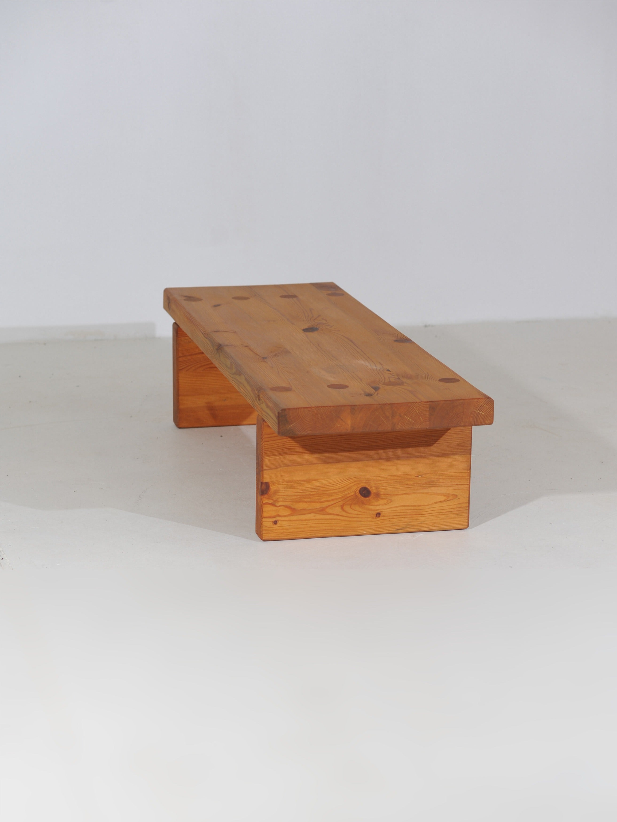 Pine bench side view showing thick wooden construction and natural grain