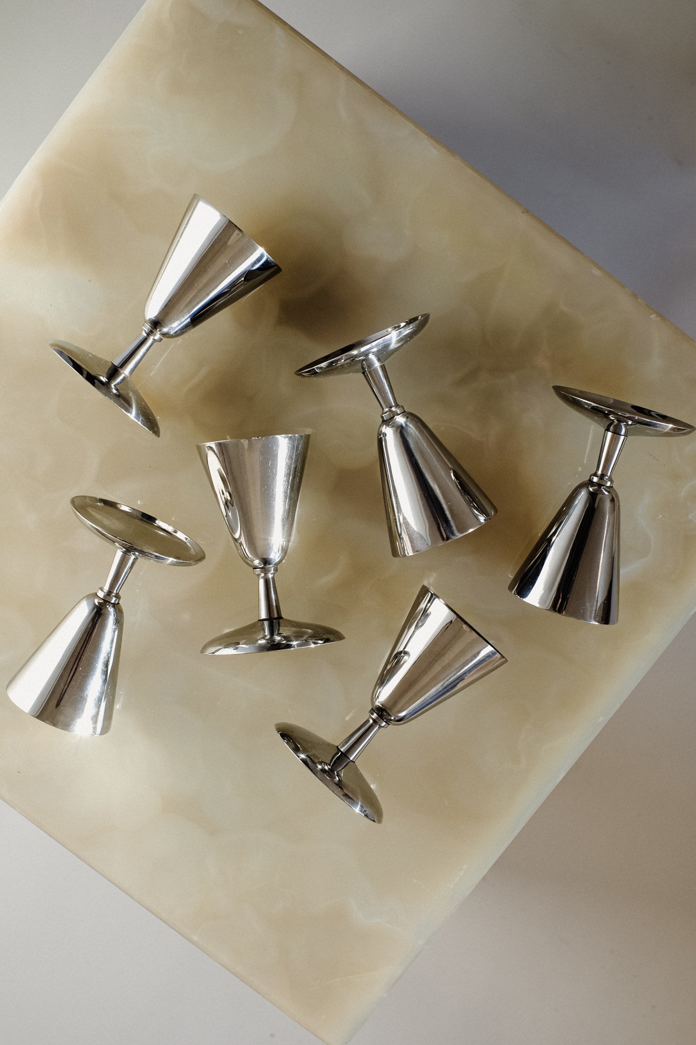 Set of 6 Coupes — top view of polished metal finish on marble surface