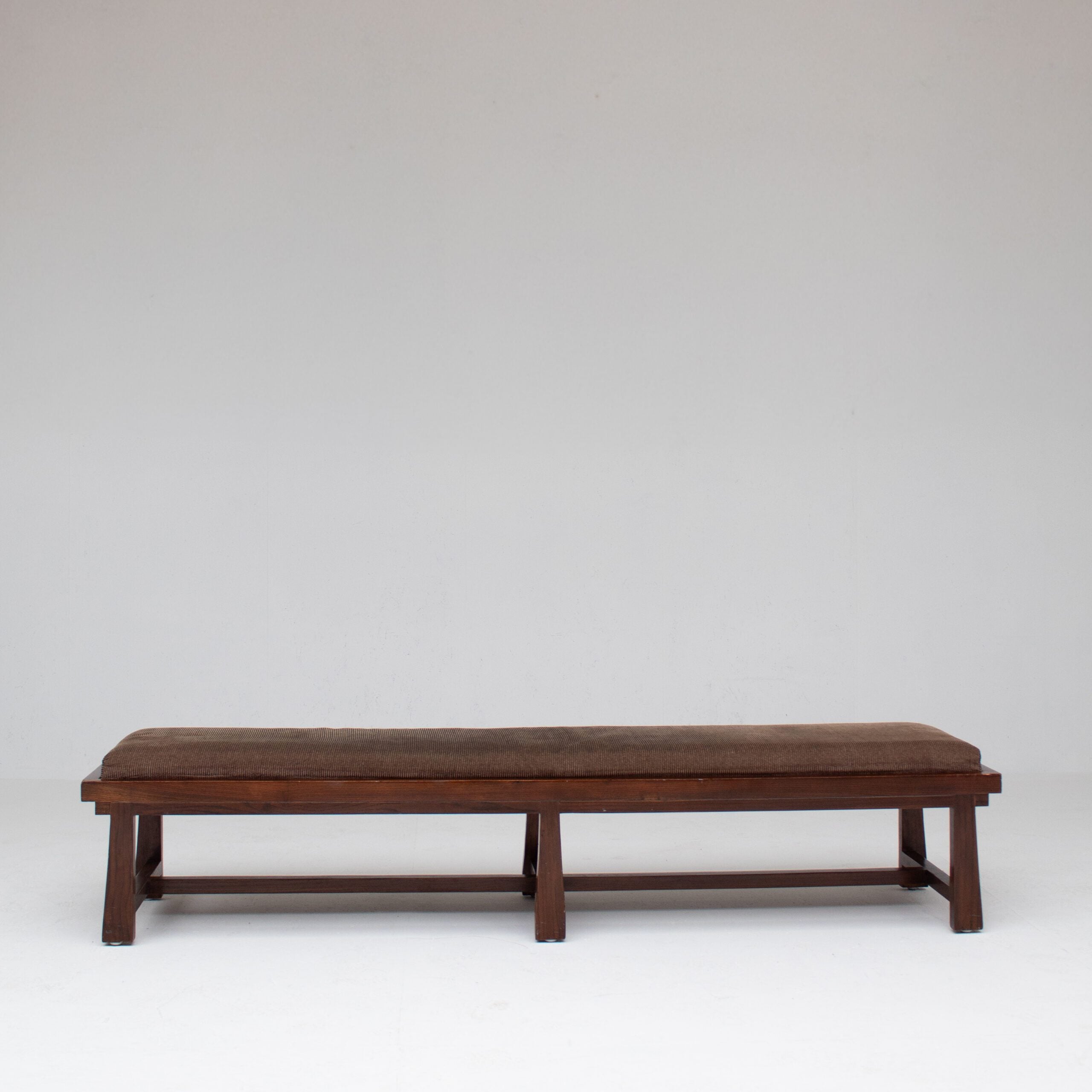 Rustique Bench in Wood with Cushion — side angle showing dark wood frame