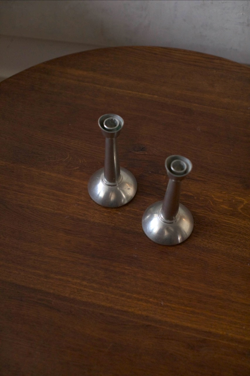 Steel Candleholders — side angle on wooden table surface