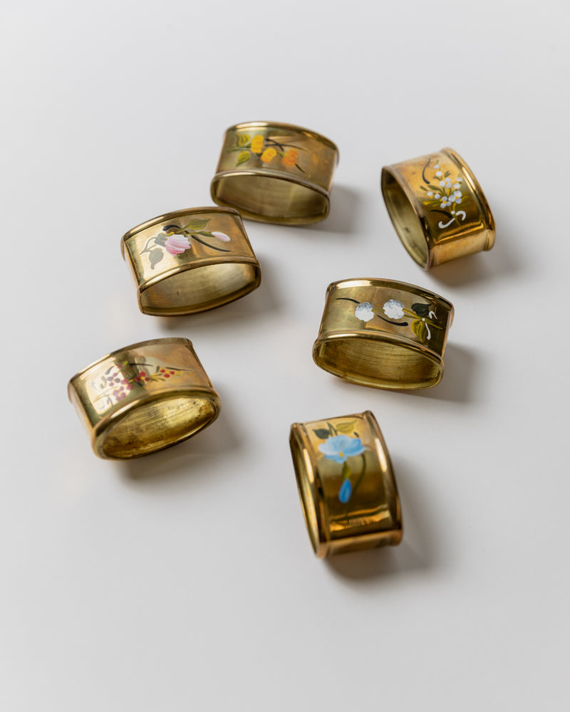 Six brass napkin rings with floral motifs, Italy 1940s detail view