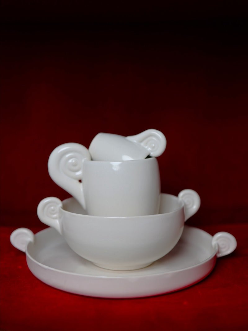 Stacked white porcelain Aries espresso cups with decorative horn handles