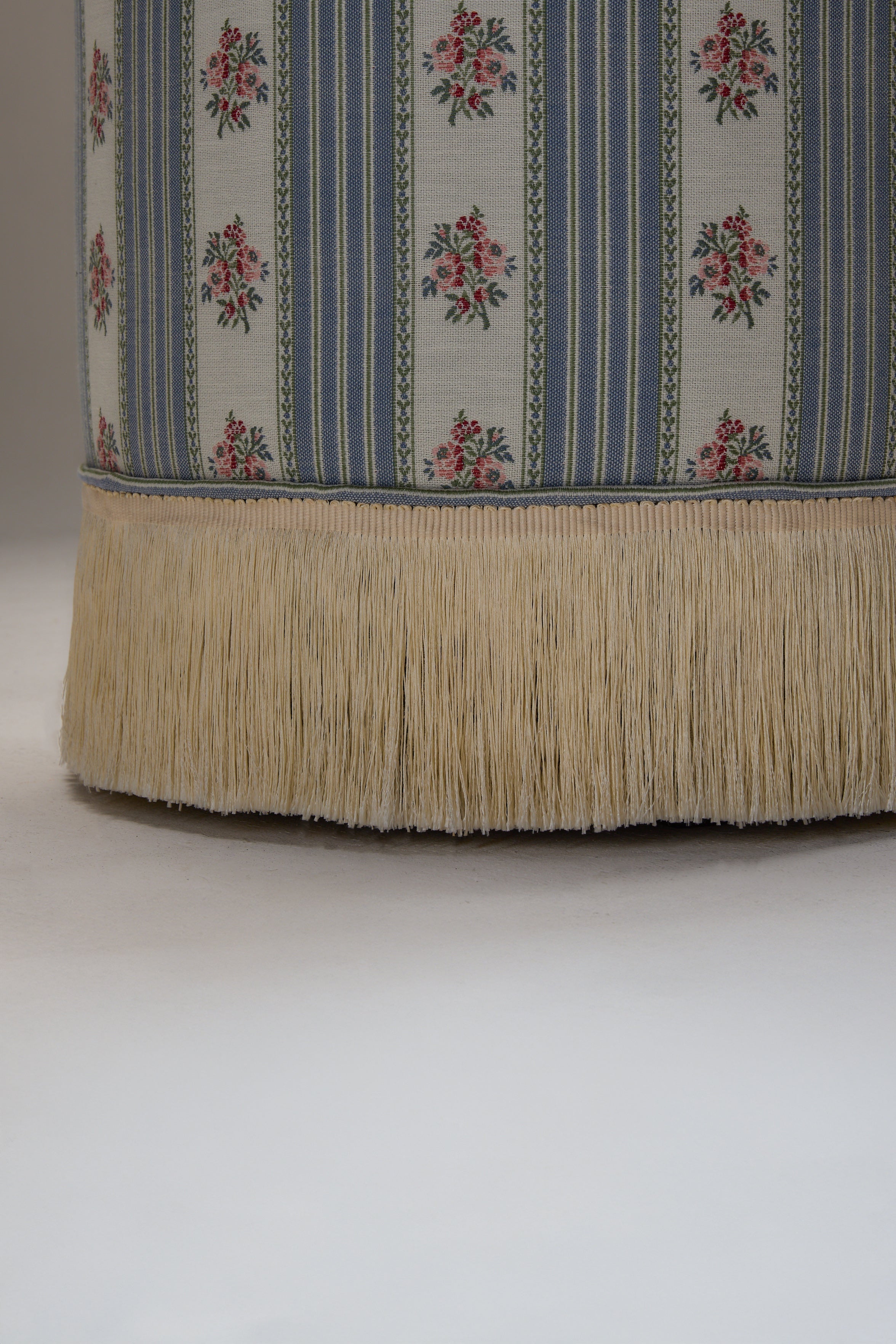 POMONA POEF - SOFA STRIPE 1 — back view of floral fabric with fringe