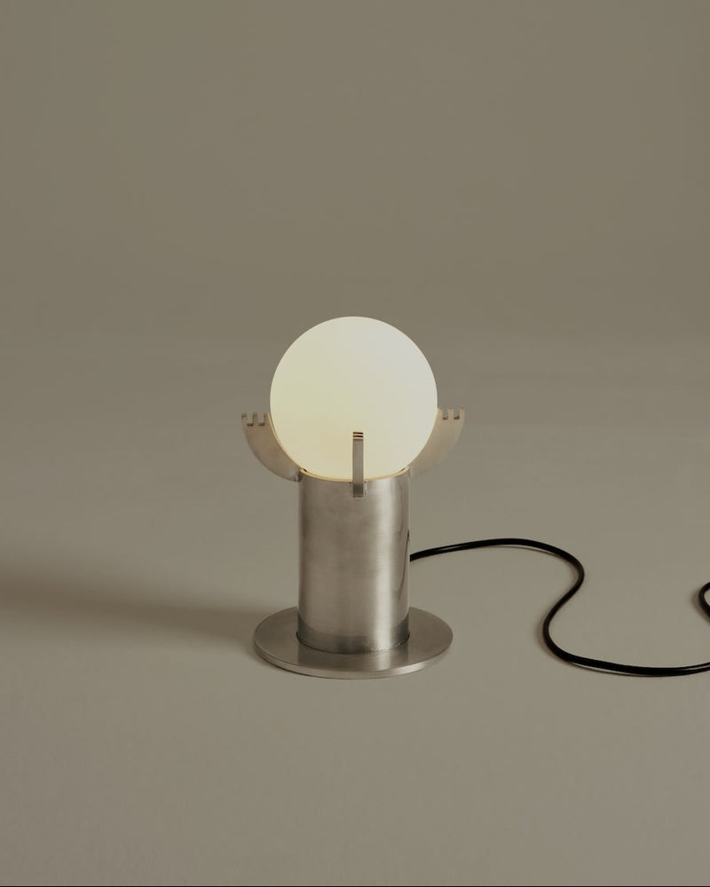 Modern Mago table lamp with glowing sphere and brushed steel base