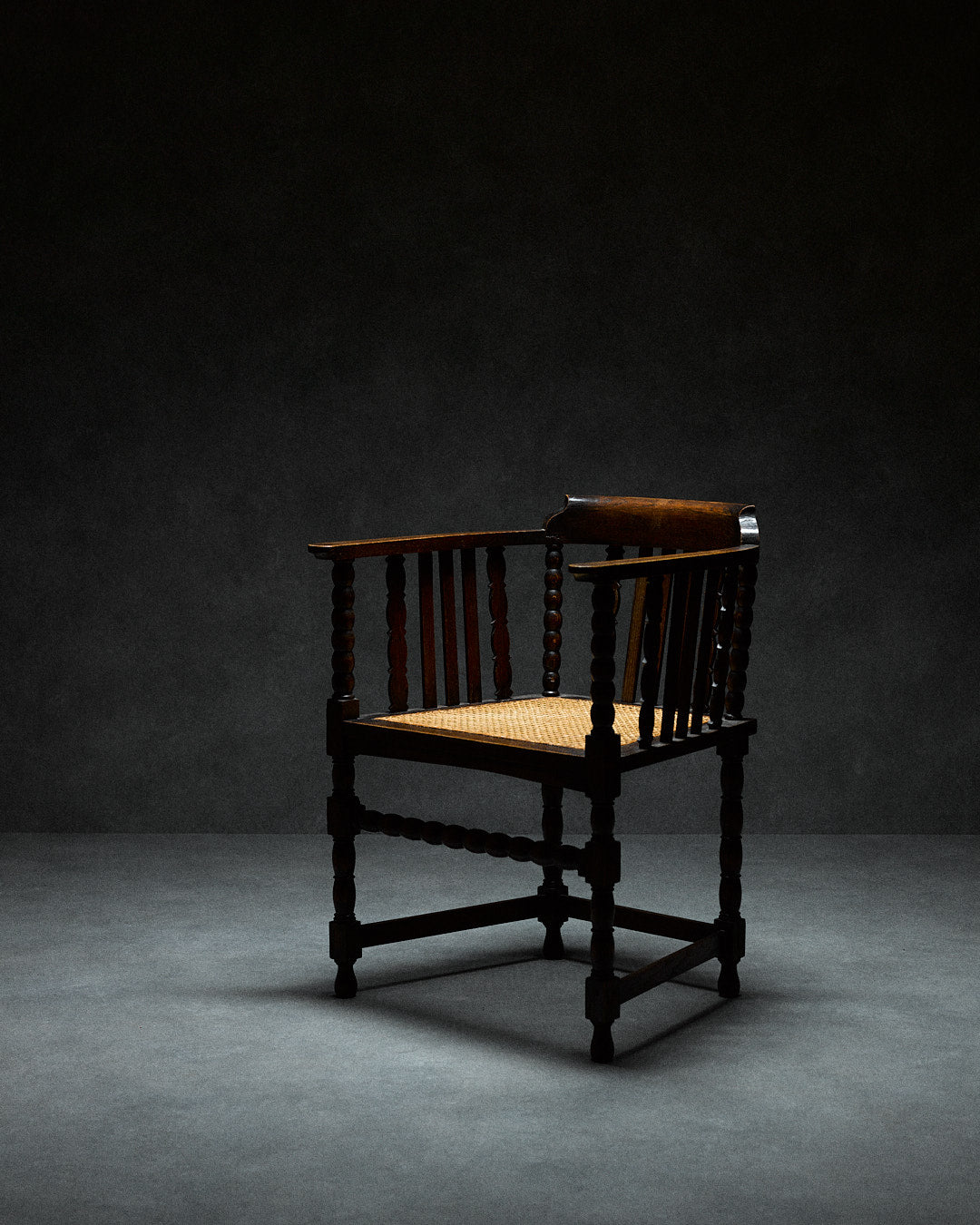Captains Chair with Cane Seating — side view highlighting cane seat and dark wood
