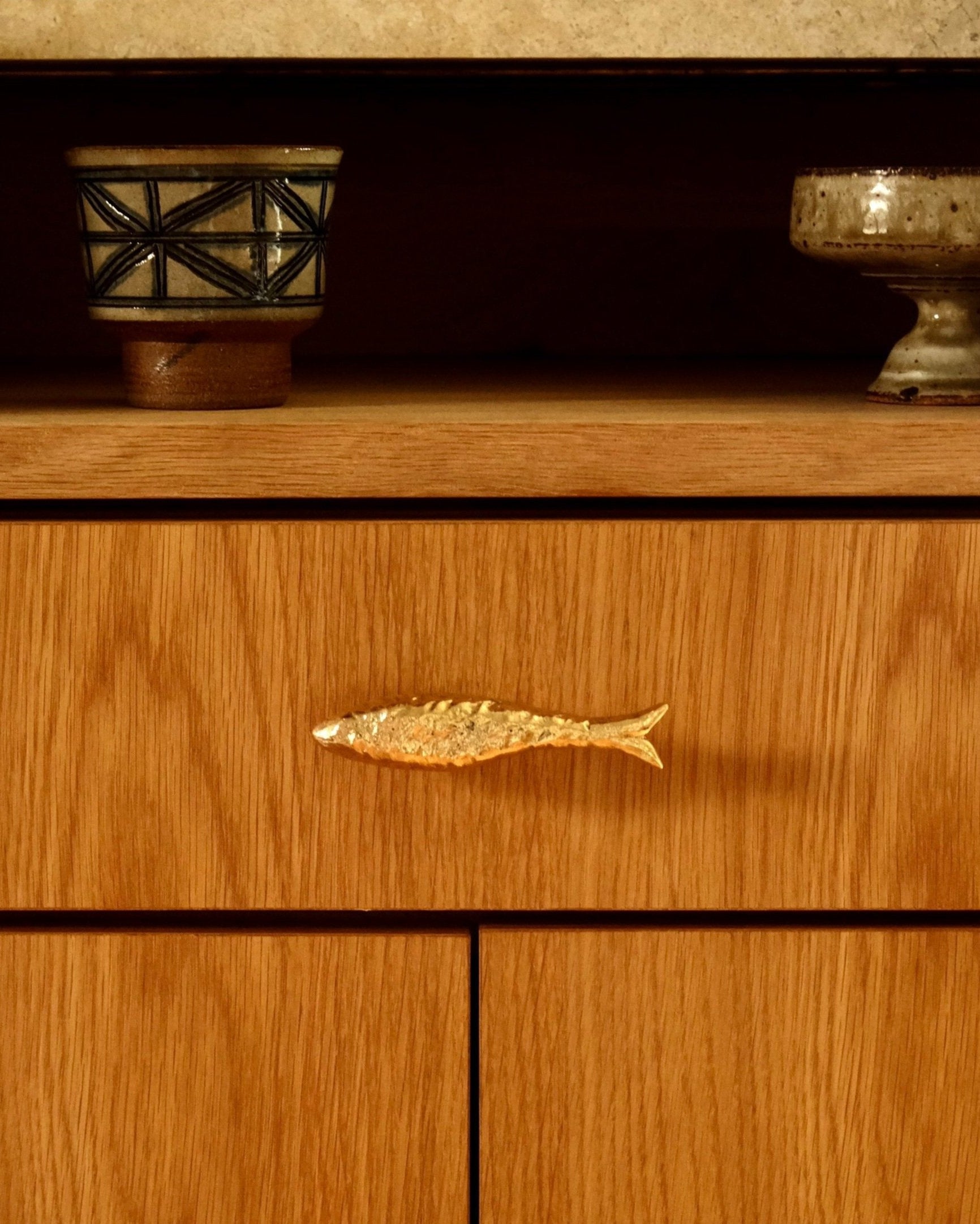 FISH Cabinet Knob/Wall Hook — close-up of gold fish design on wood drawer
