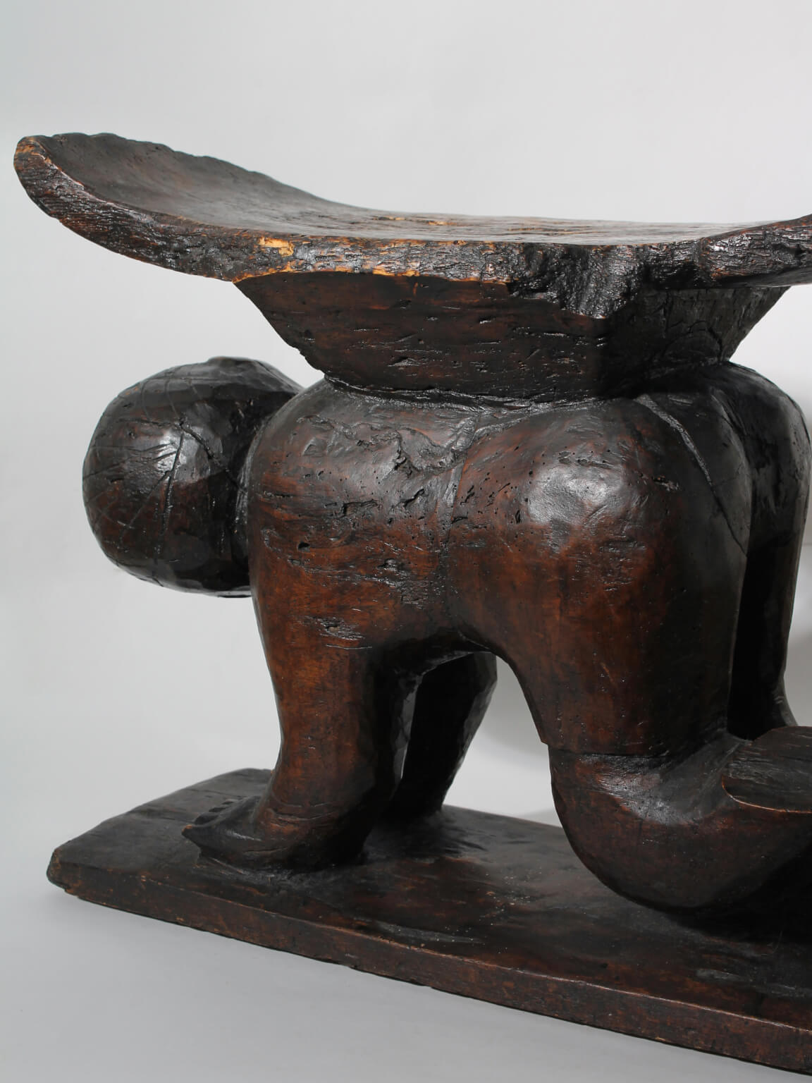 Large African Ashanti Figural Stool — side view highlighting dark wood finish