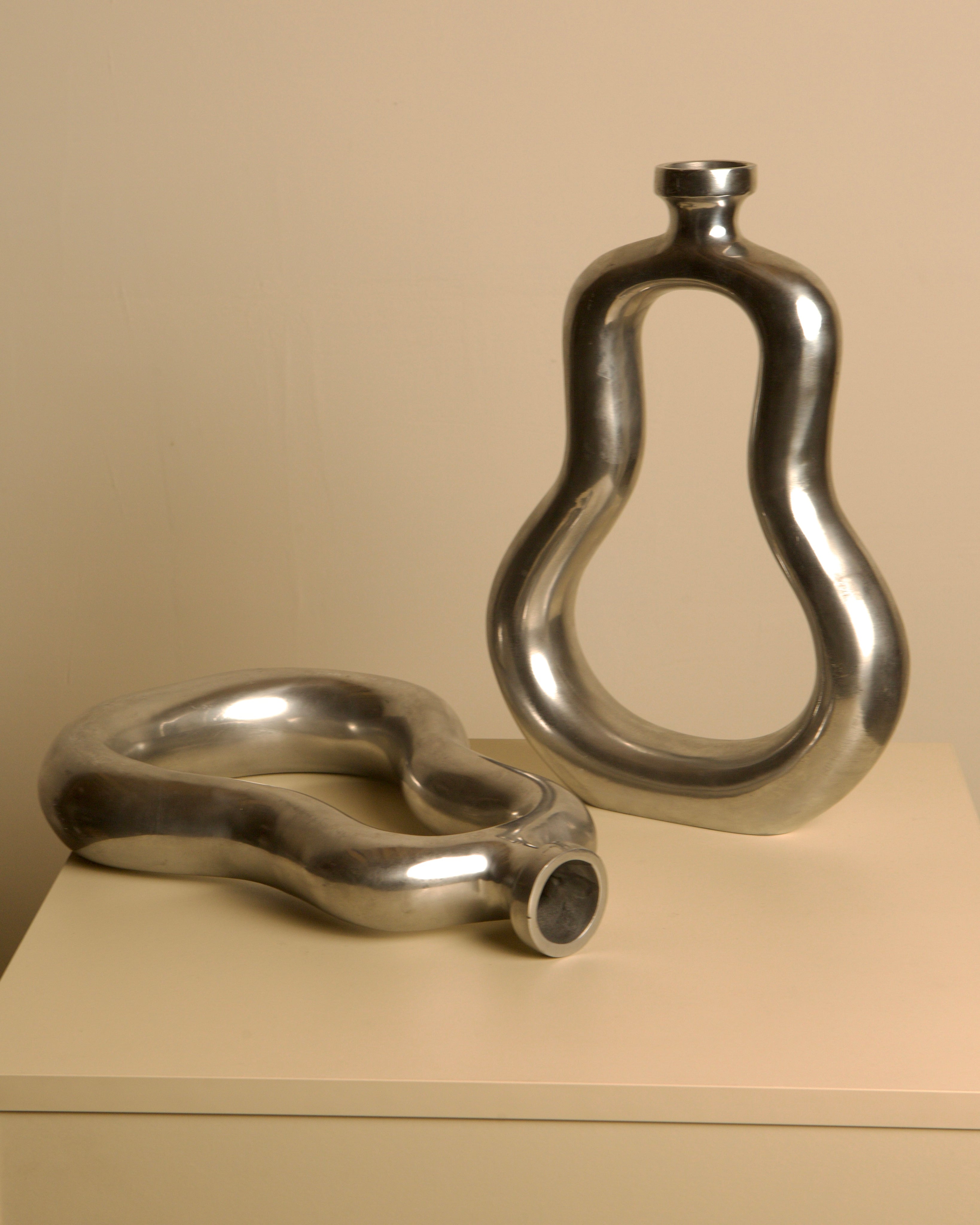 Pair of Italian Cast Aluminum Vases 1980s — side angle on neutral background