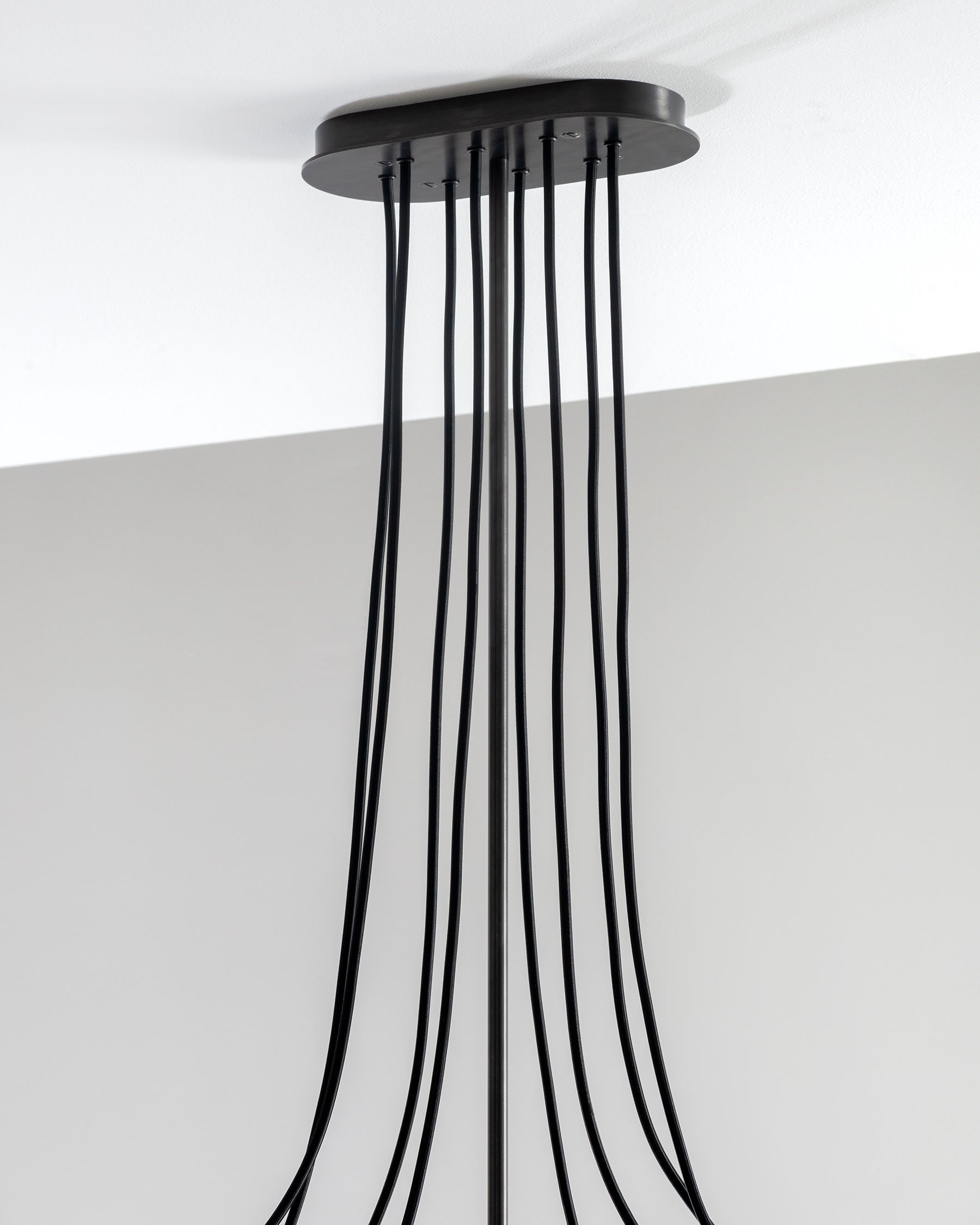 SkLO Drape Arm 8 Chandelier - Olivin glass, Dark Oxidized finish — lifestyle setting