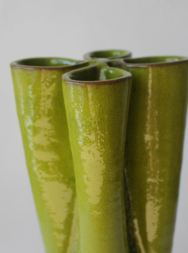 Closeup detail of green ceramic vase with glossy retro glaze finish