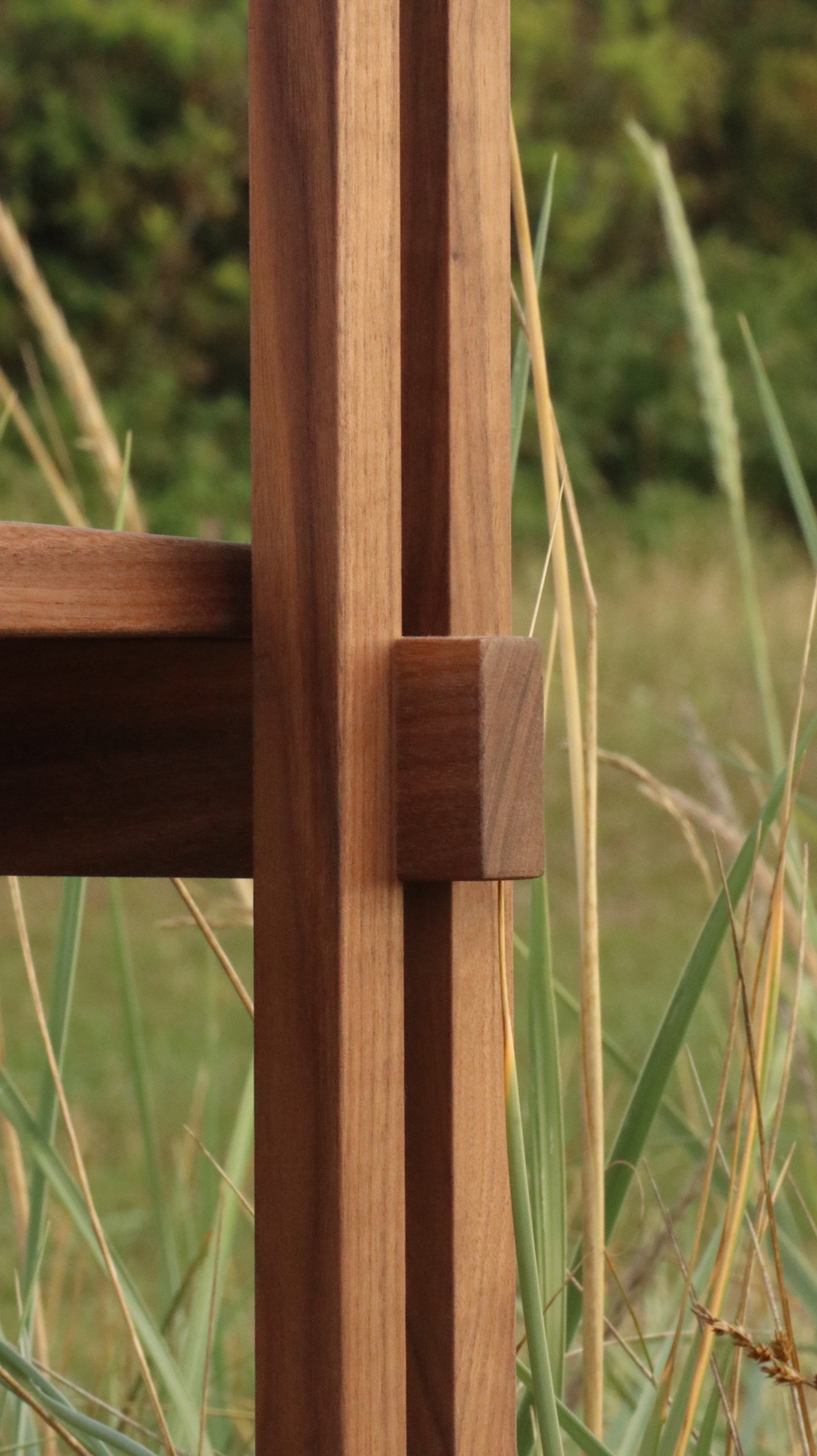 Stack chair with armrests — back view highlighting wooden frame detail