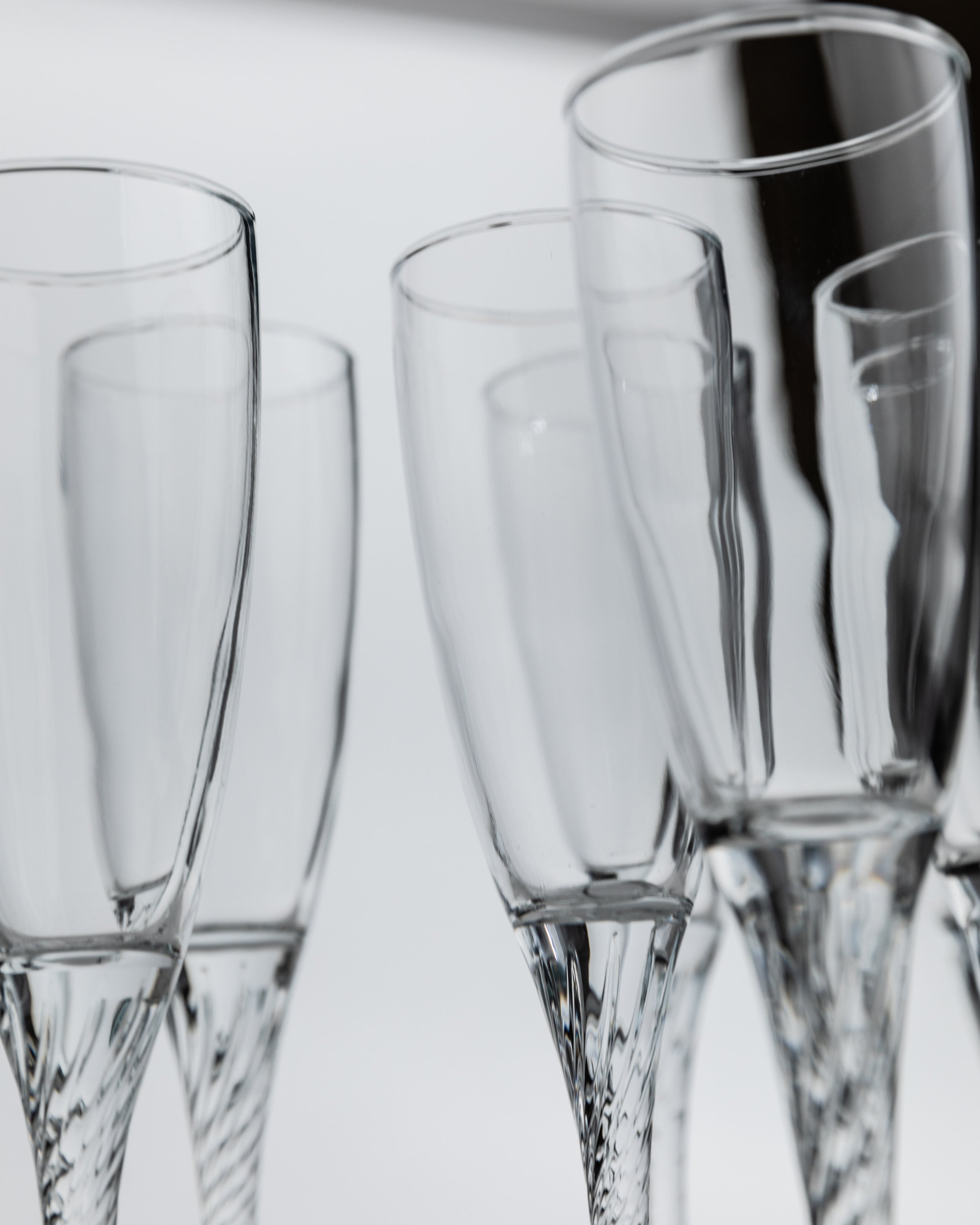 Crystal champagne flutes with cut glass stems detail view