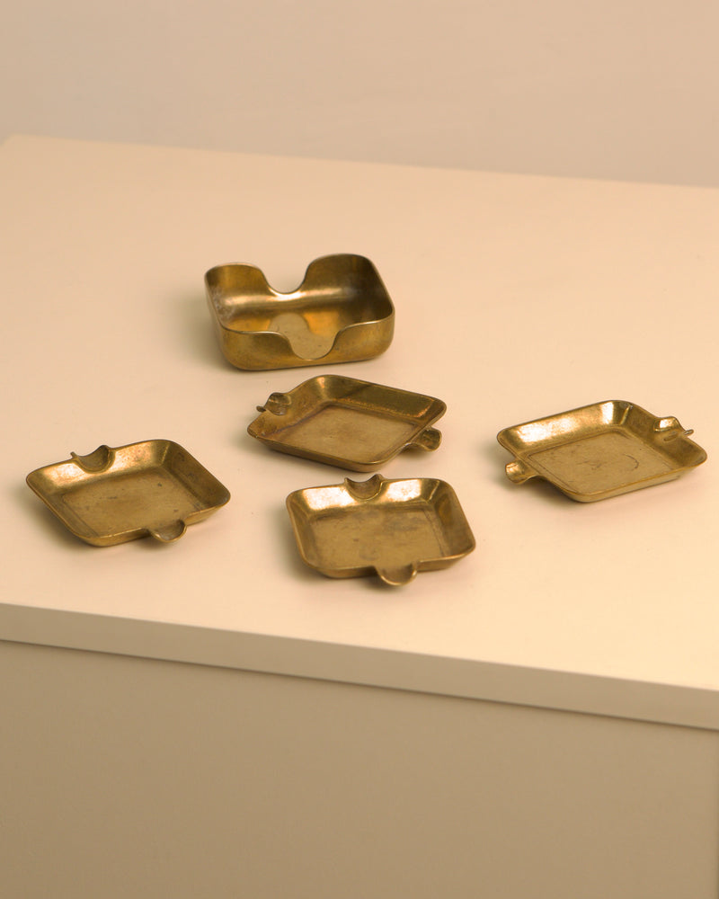 Set of five Italian brass ashtrays from 1960s with curved edges