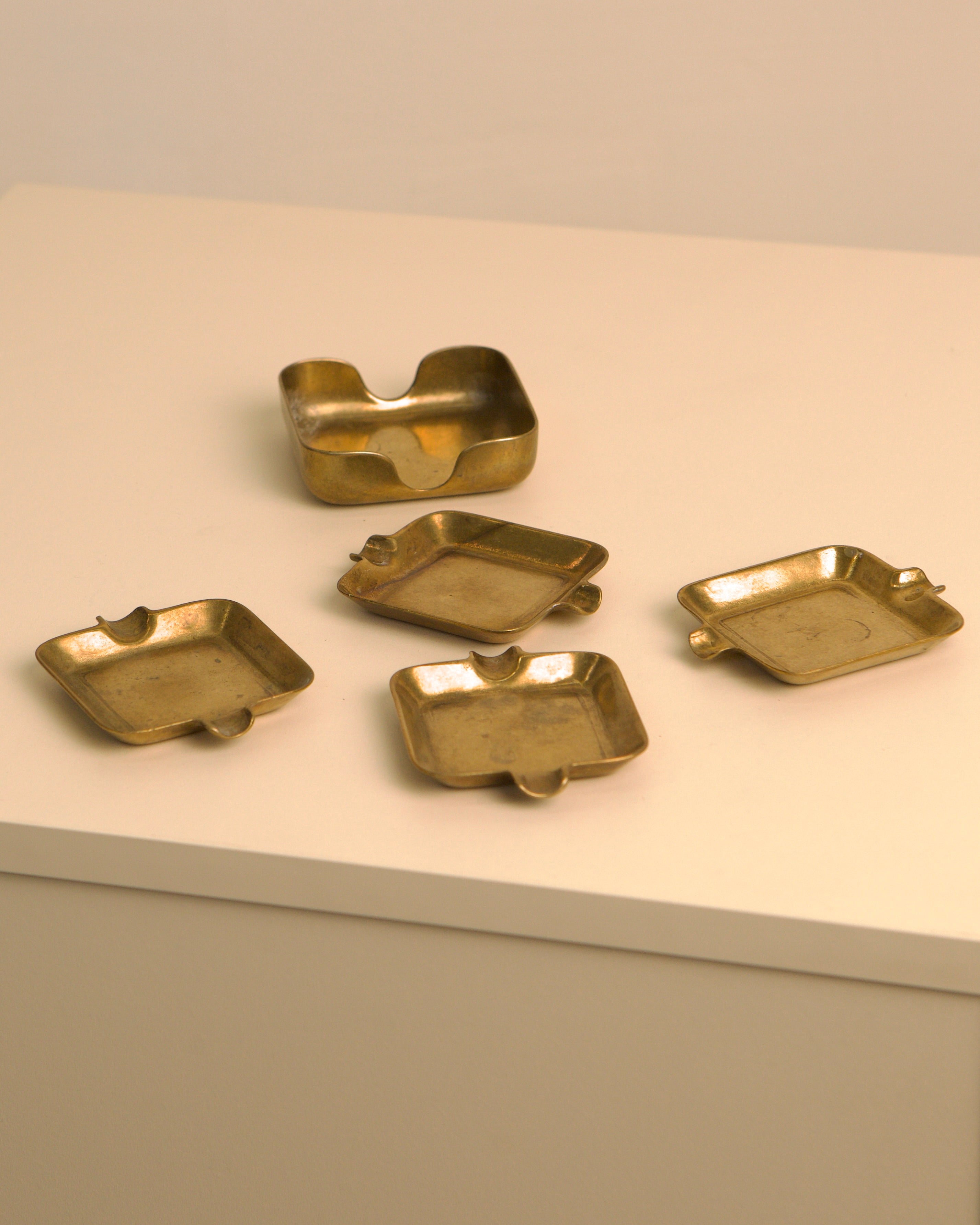 Set of five Italian brass ashtrays from 1960s with curved edges