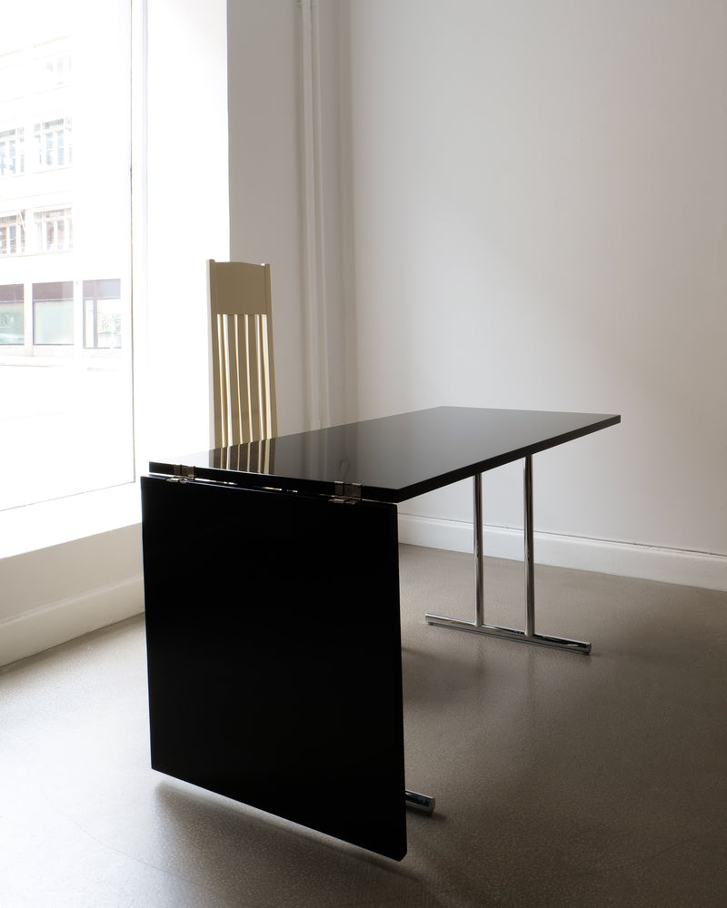 Black lacquered extendable desk with chrome legs by Eileen Gray