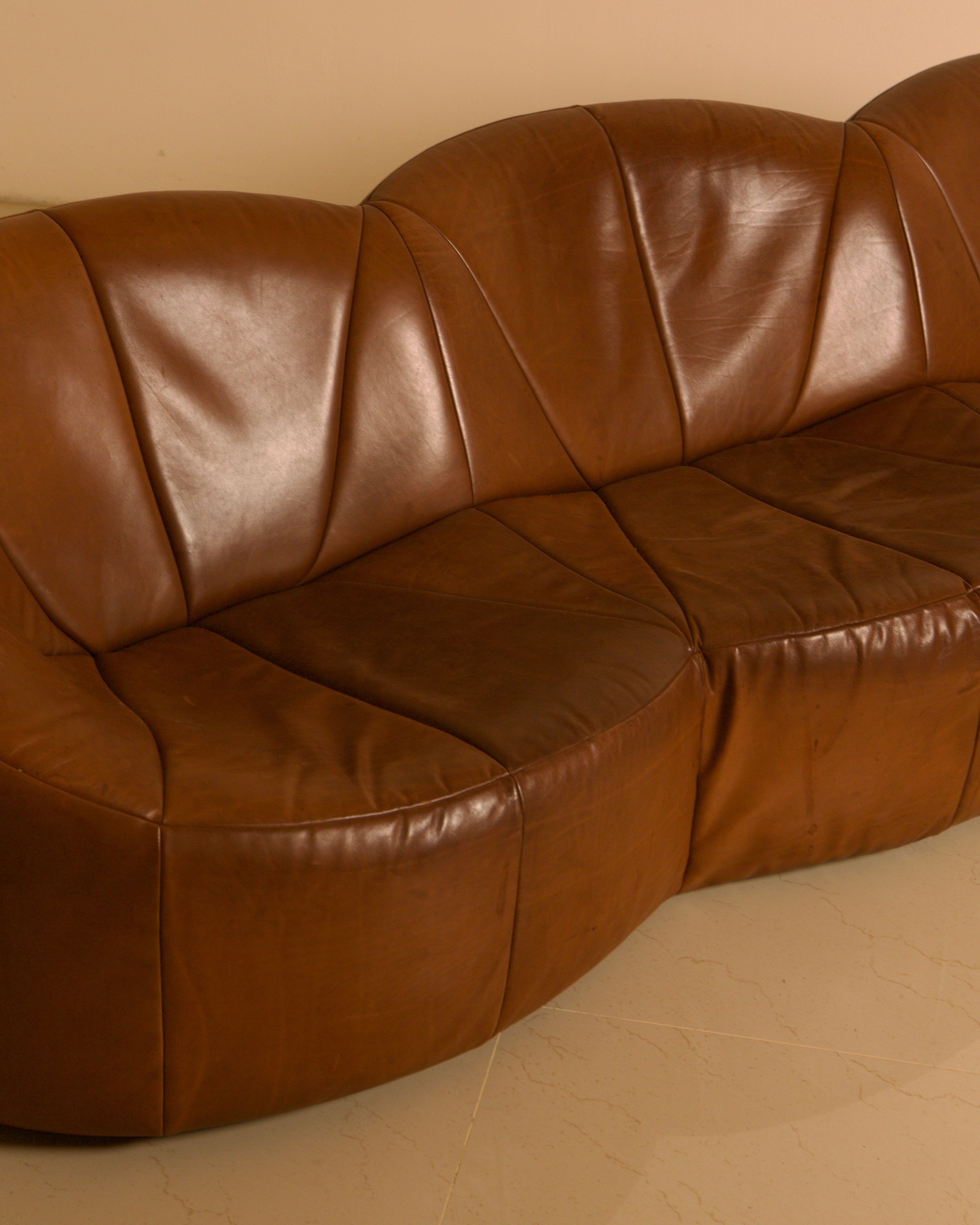 Three-seater "Pumpkin" Sofa by Pierre Paulin for Artifort, 1980 — angled view highlighting rich brown leather upholstery