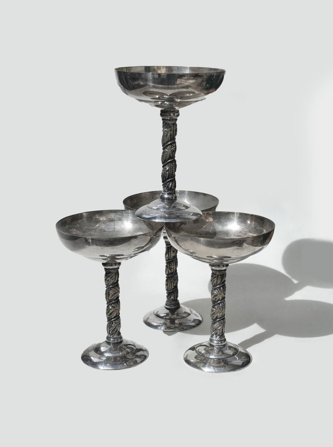 Set of 4 elegant glass coupe glasses with ornate twisted stems