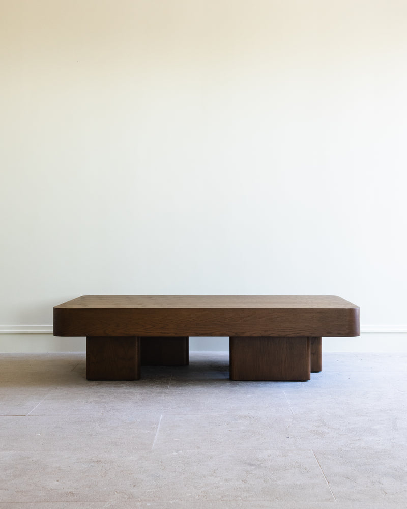 Chalette walnut coffee table with geometric block base by Studio OSKLO