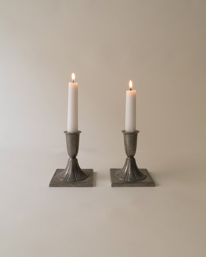 Pair of pewter candlesticks with lit candles, 1930s Just Andersen