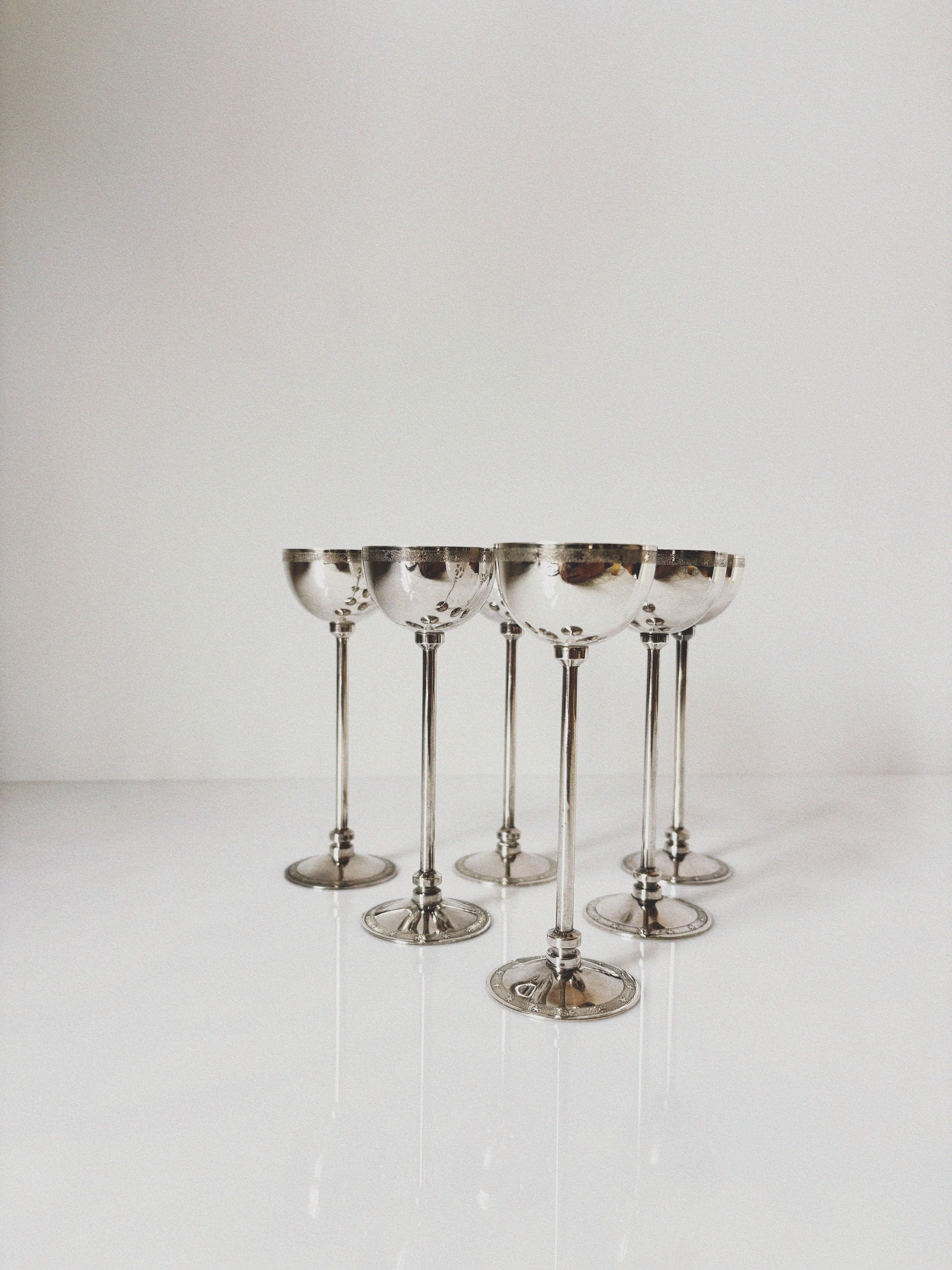 Set of six silver-rimmed champagne coupes with metallic stems