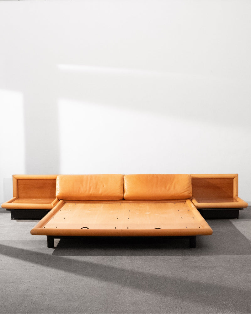 Low-angle view of Morna leather platform bed with side tables