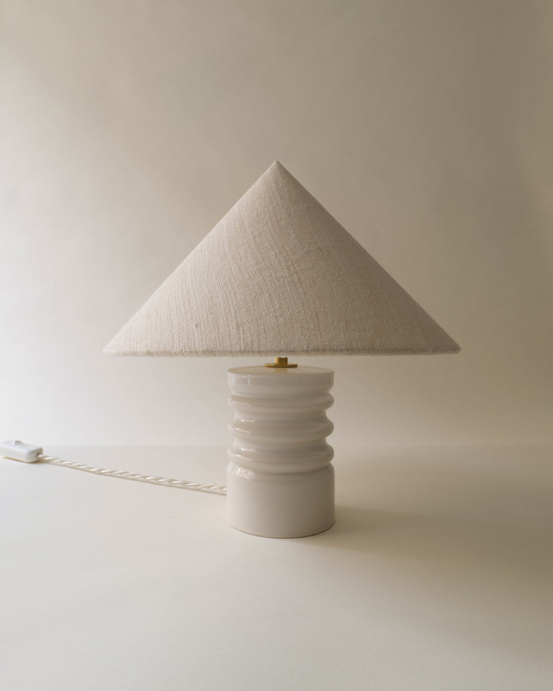 Sculptural ceramic table lamp with triangular linen shade