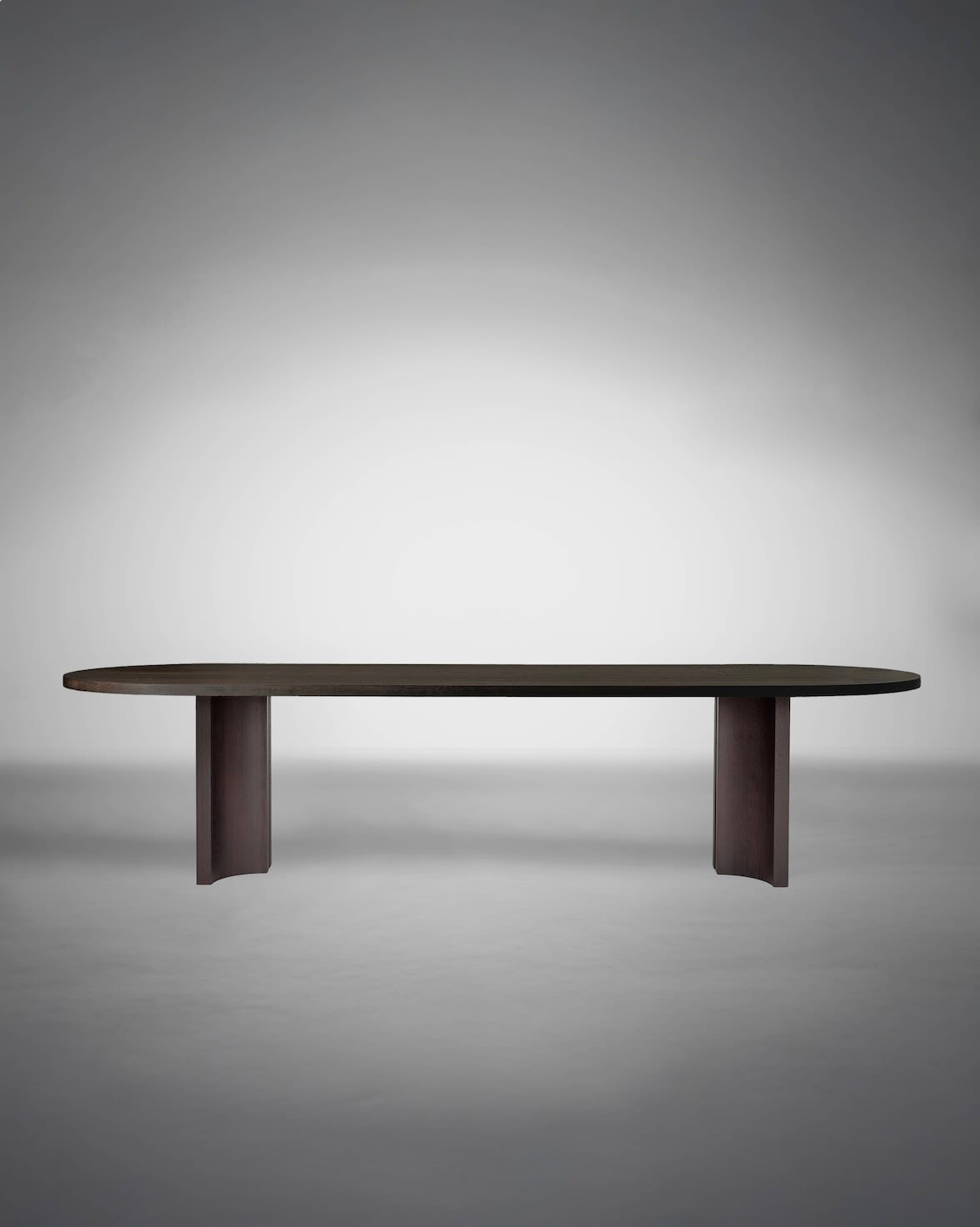 Aperta Capsule Table - Single Base — top view of dark wood surface