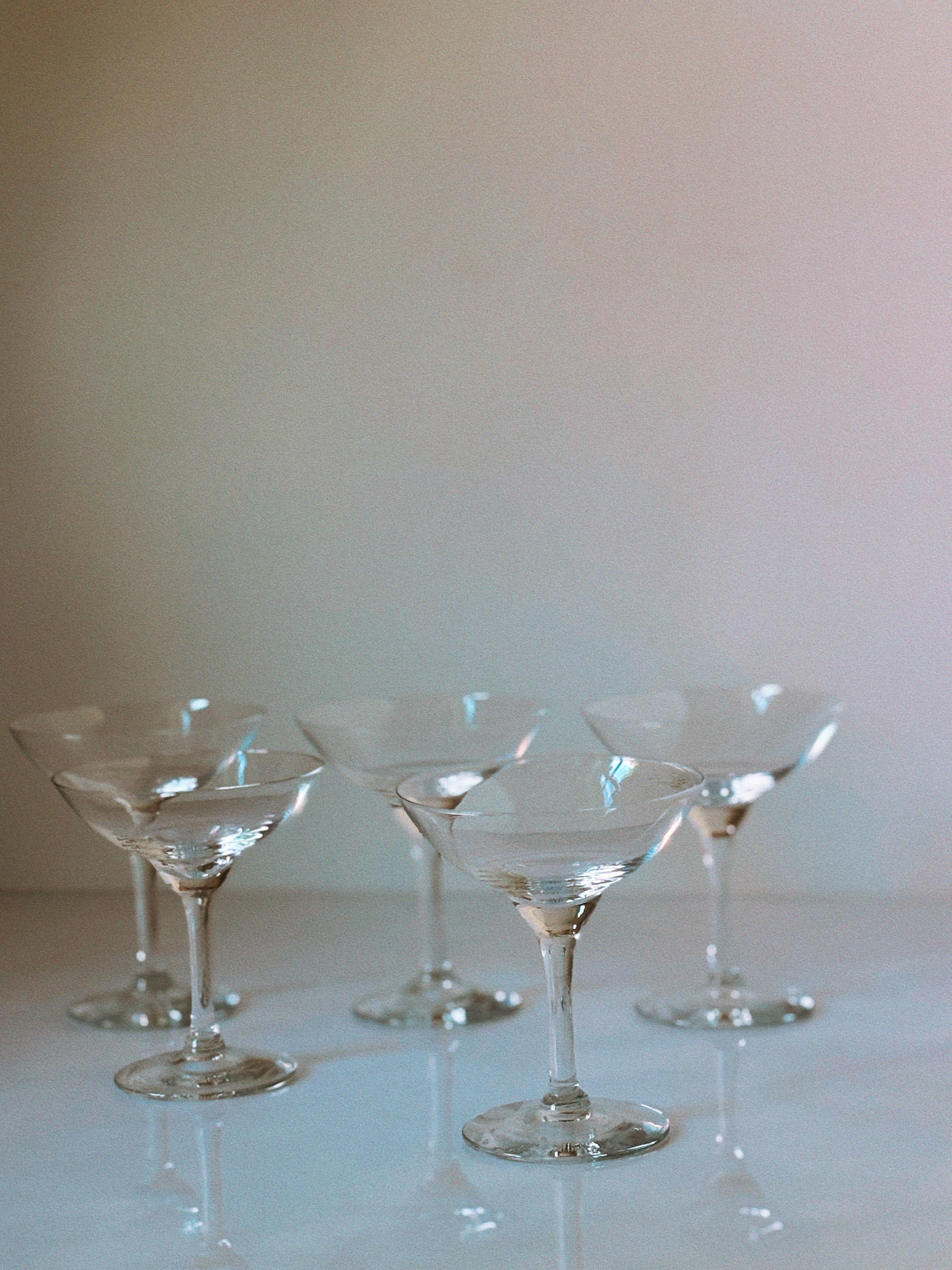 Art Deco cocktail glasses atmospheric view with soft lighting