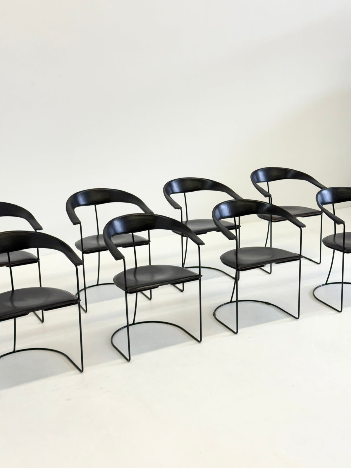 Set of 8 Vintage Arrben Ursala dining chairs in black leather — side angle
