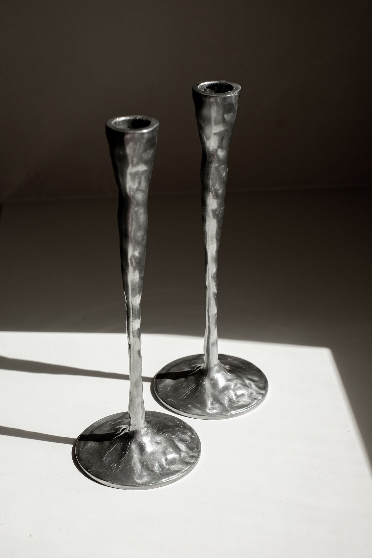 Pair of Aluminium Candle Holders — close-up of textured metal surface